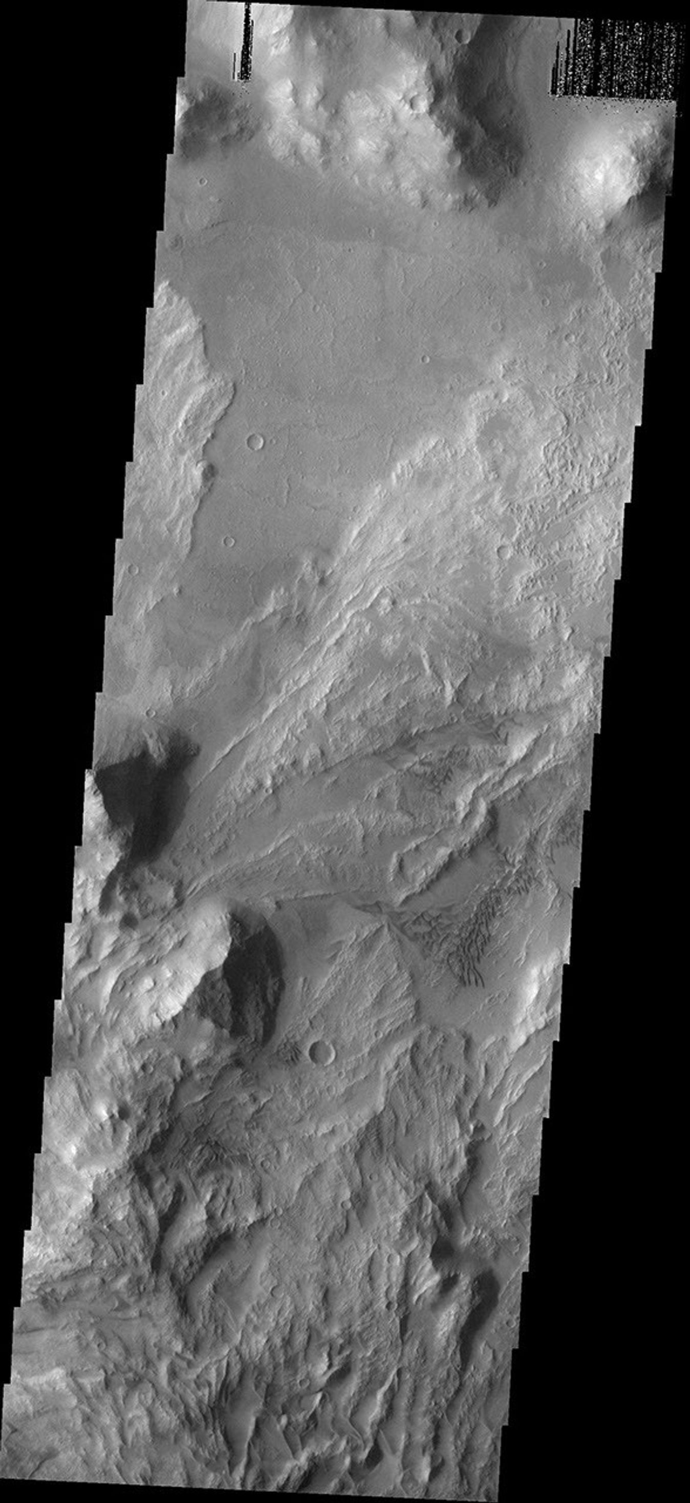 The dunes and landslides in this image occur within Coprates Chasma on Mars as seen by NASA's 2001 Mars Odyssey spacecraft.