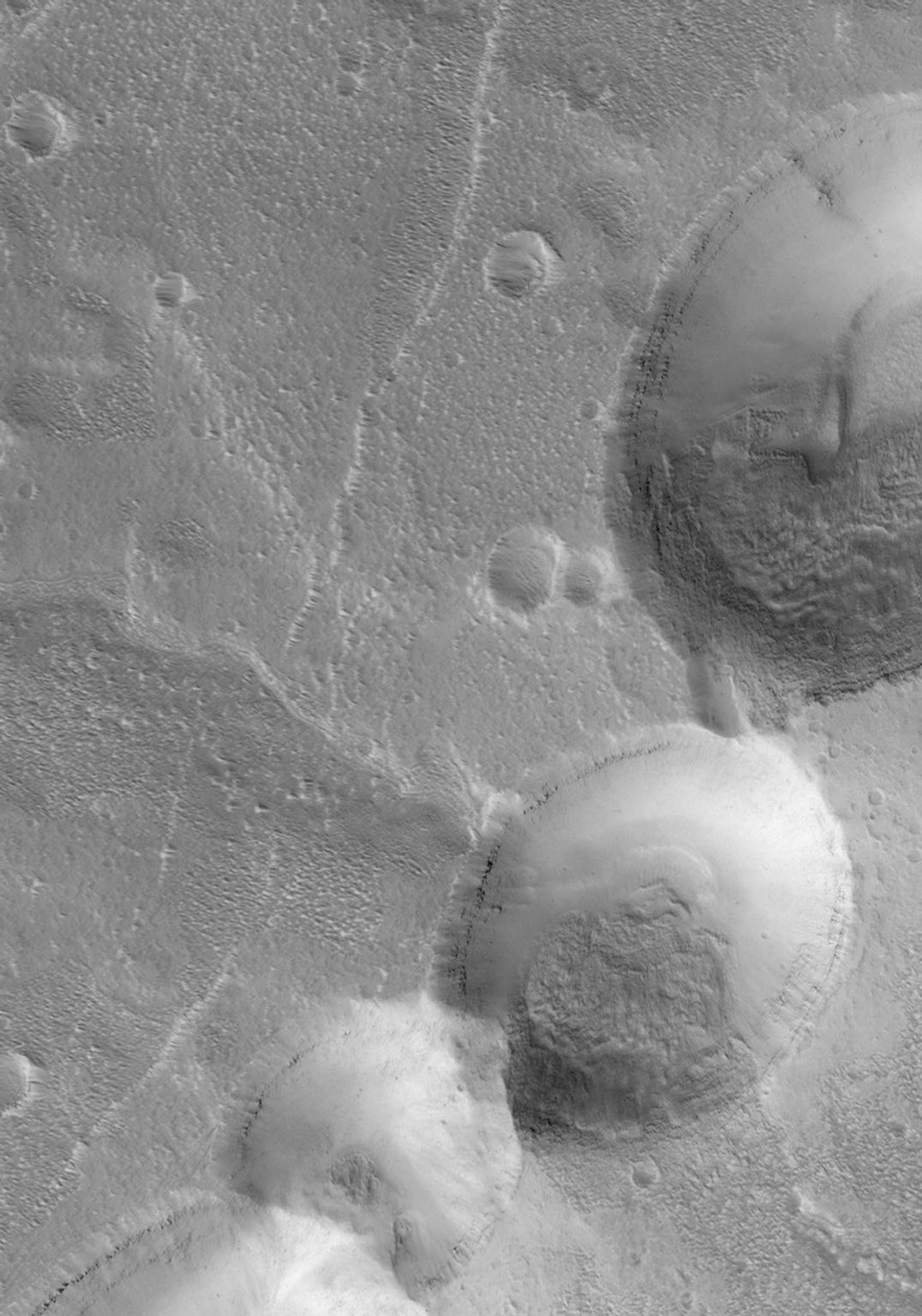 This NASA Mars Global Surveyor image shows partially-filled collapse pits on the eastern flank of Alba Patera, a large volcano in northern Tharsis.