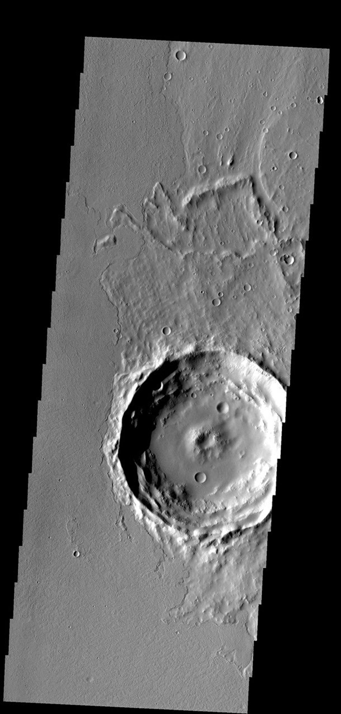 Located on the eastern edge of the Tharsis region on Mars, this crater has had half of its ejecta covered by lava flows as seen by NASA's 2001 Mars Odyssey.