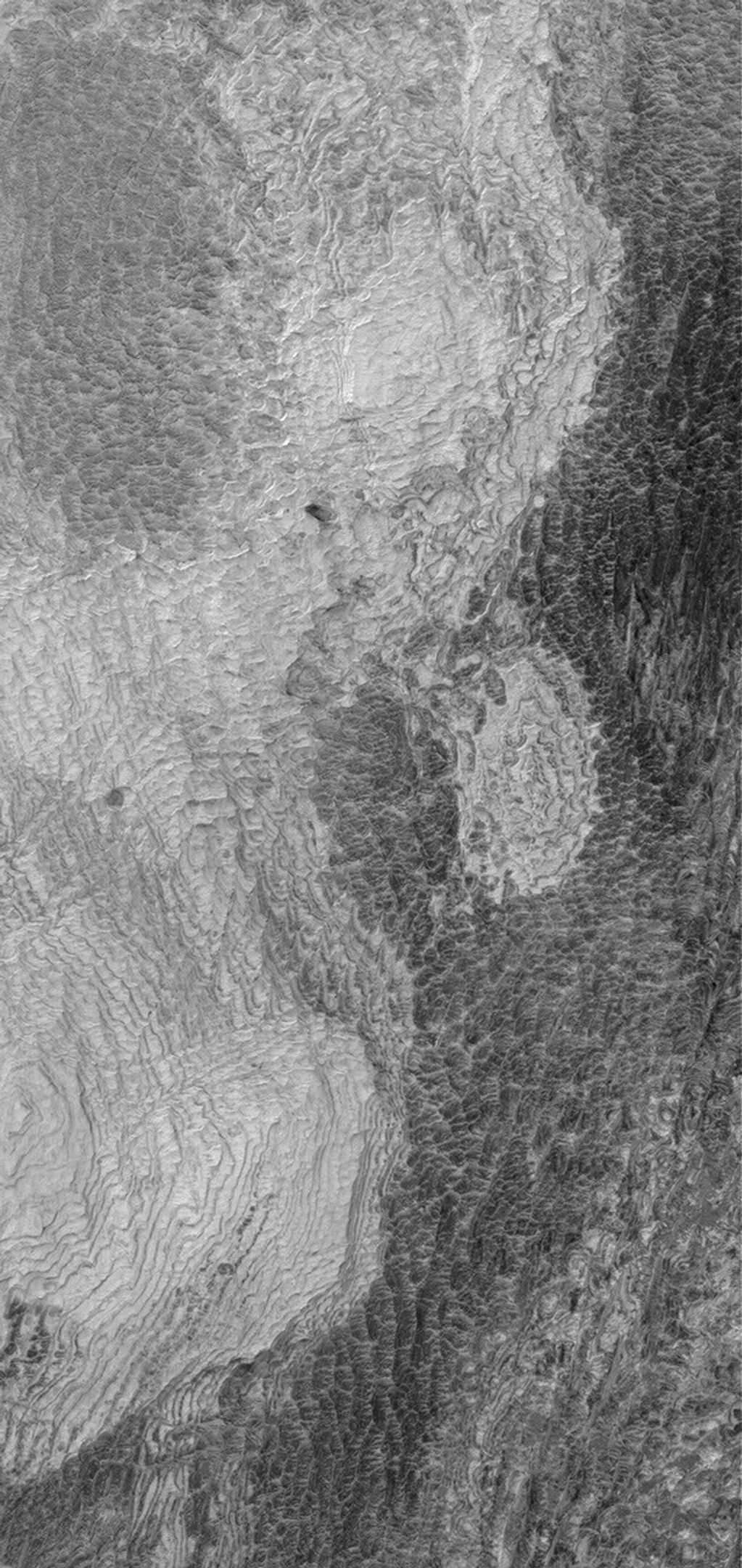 NASA's Mars Global Surveyor shows light-toned, layered, sedimentary rock outcrops in northwest Schiaparelli Basin on Mars. The layers are all of about the same thickness (a few meters or less) and appear to have similar properties.