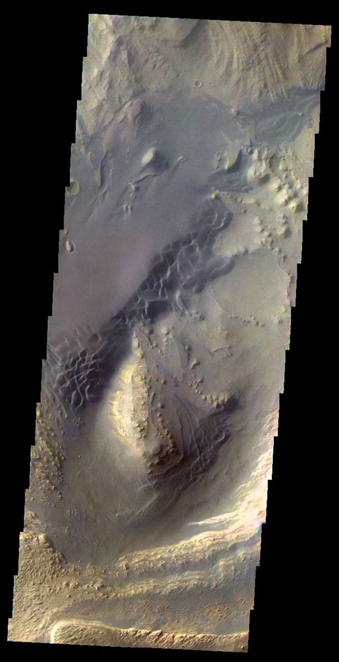This image from NASA's 2001 Mars Odyssey shows the sand dunes and layered material common on the floor of Valles Marineris.