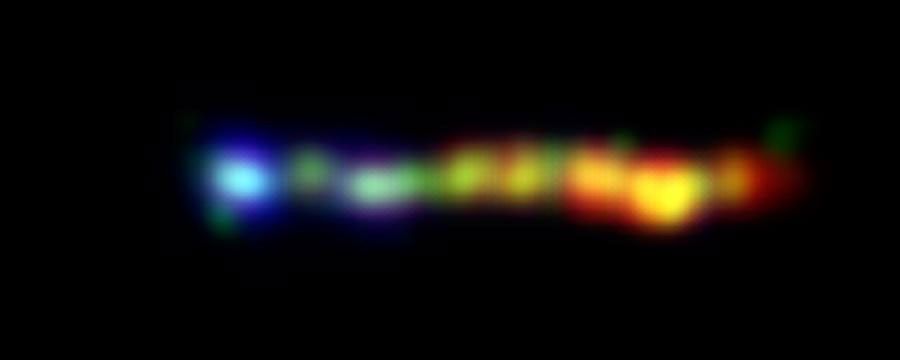 This new false-colored image from NASA's Hubble, Chandra and Spitzer space telescopes shows a giant jet of particles that has been shot out from the vicinity of a type of supermassive black hole called a quasar.