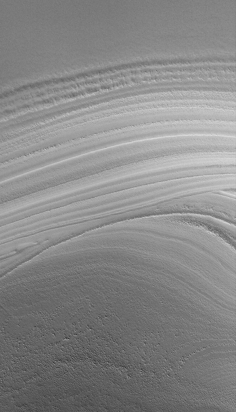 NASA's Mars Global Surveyor shows an unconformity in a sequence of layered material in the martian north polar region created by erosion.