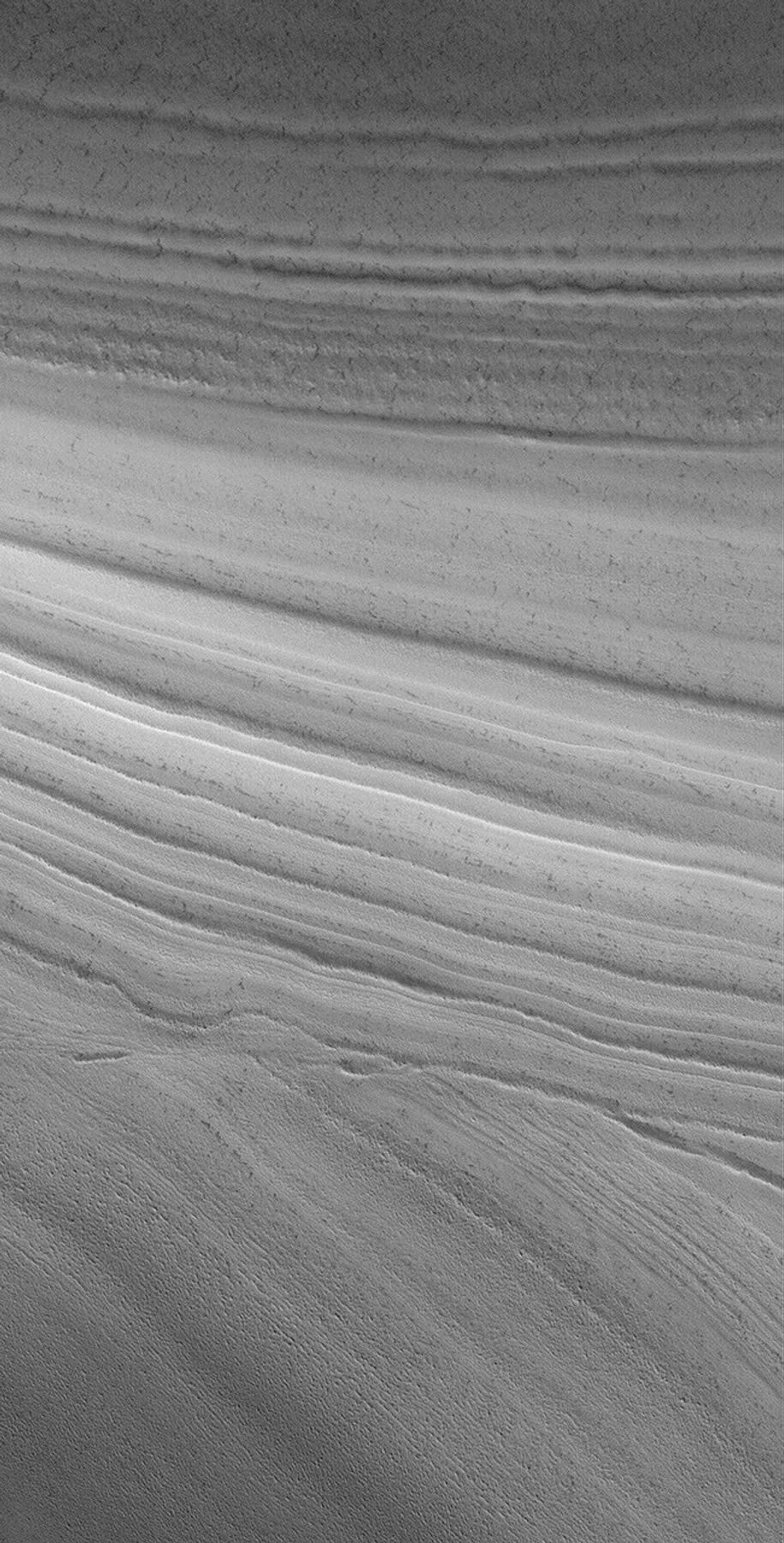 NASA's Mars Global Surveyor shows an unconformity in an exposure of the martian north polar layered material, at which older layers were cut-off and eroded before a new suite of layers was deposited above them.