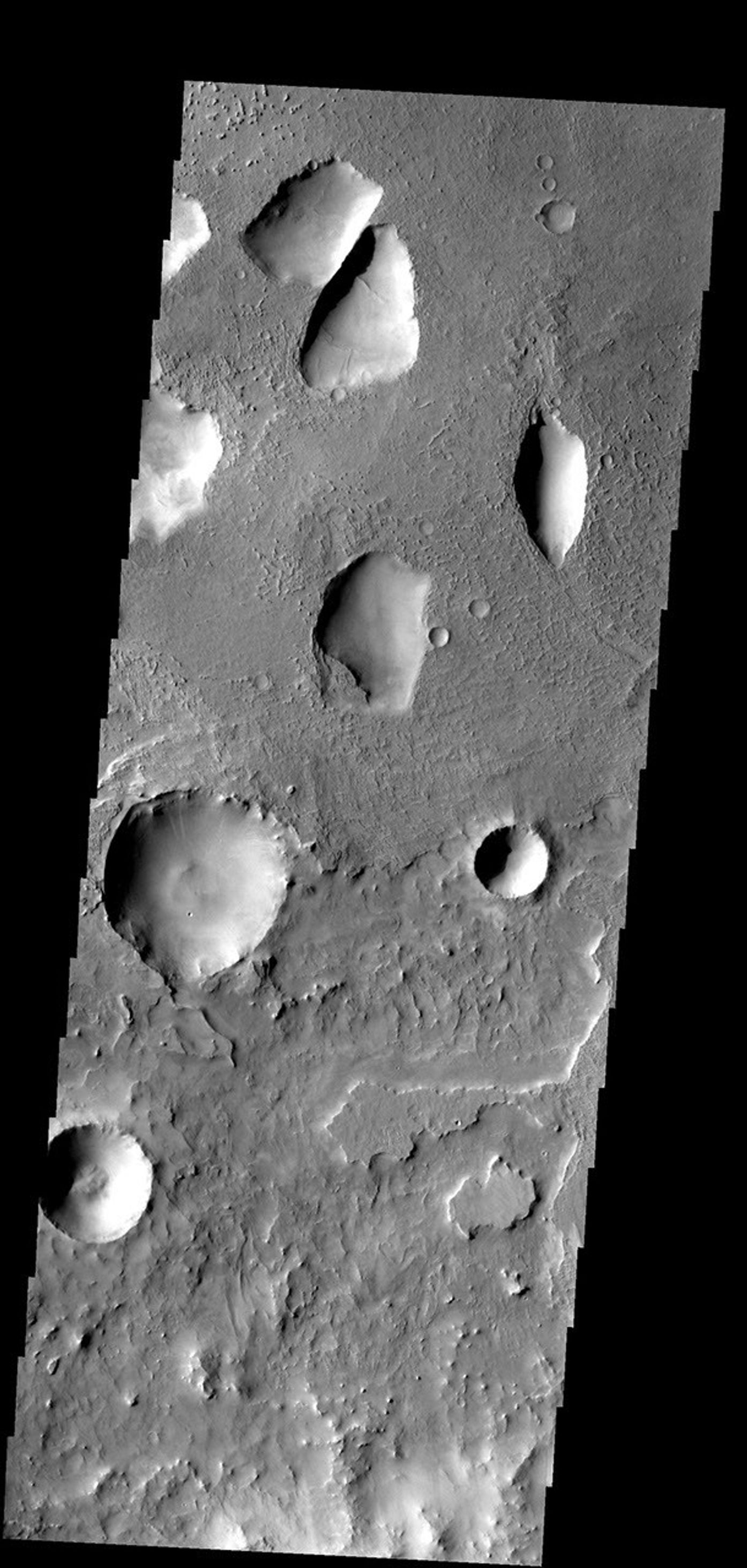 These odd shaped pits occur on the floor of a large crater in Terra Sabaea on Mars as seen by NASA's Mars Odyssey spacecraft.
