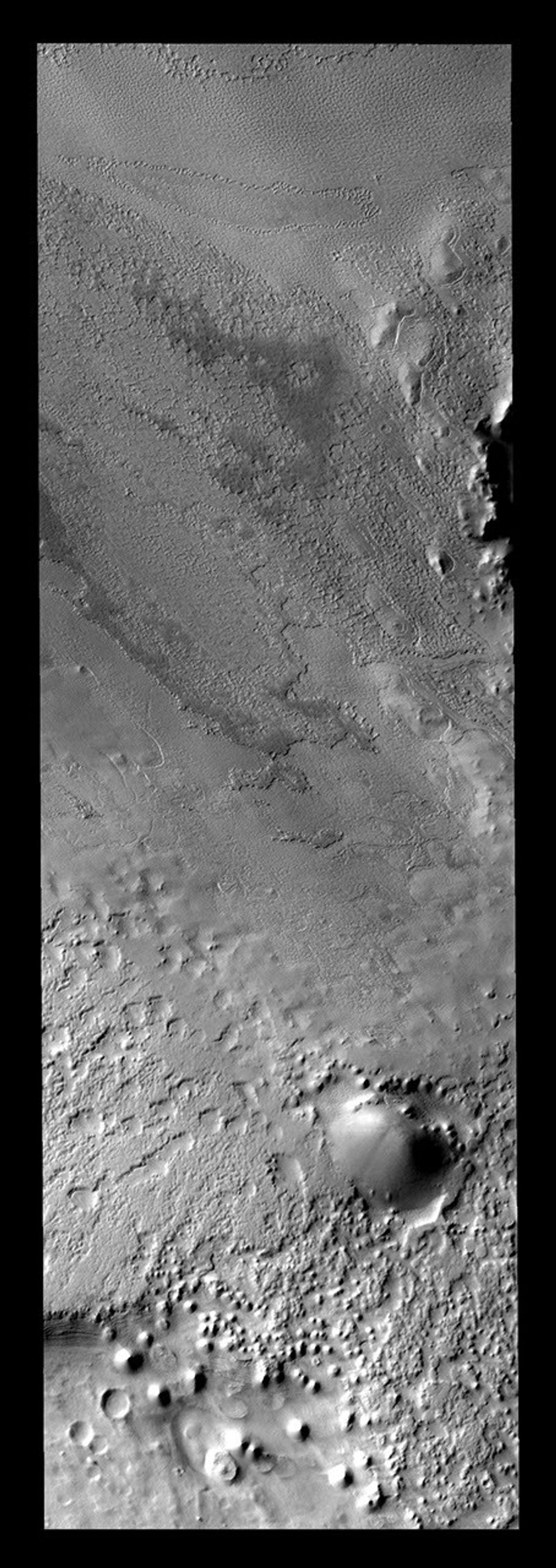 Once the summer sun has removed all the frost, the surface texture of the polar cap ice is visible. Many different textures exist in the ice on Mars as seen by NASA's Mars Odyssey spacecraft.