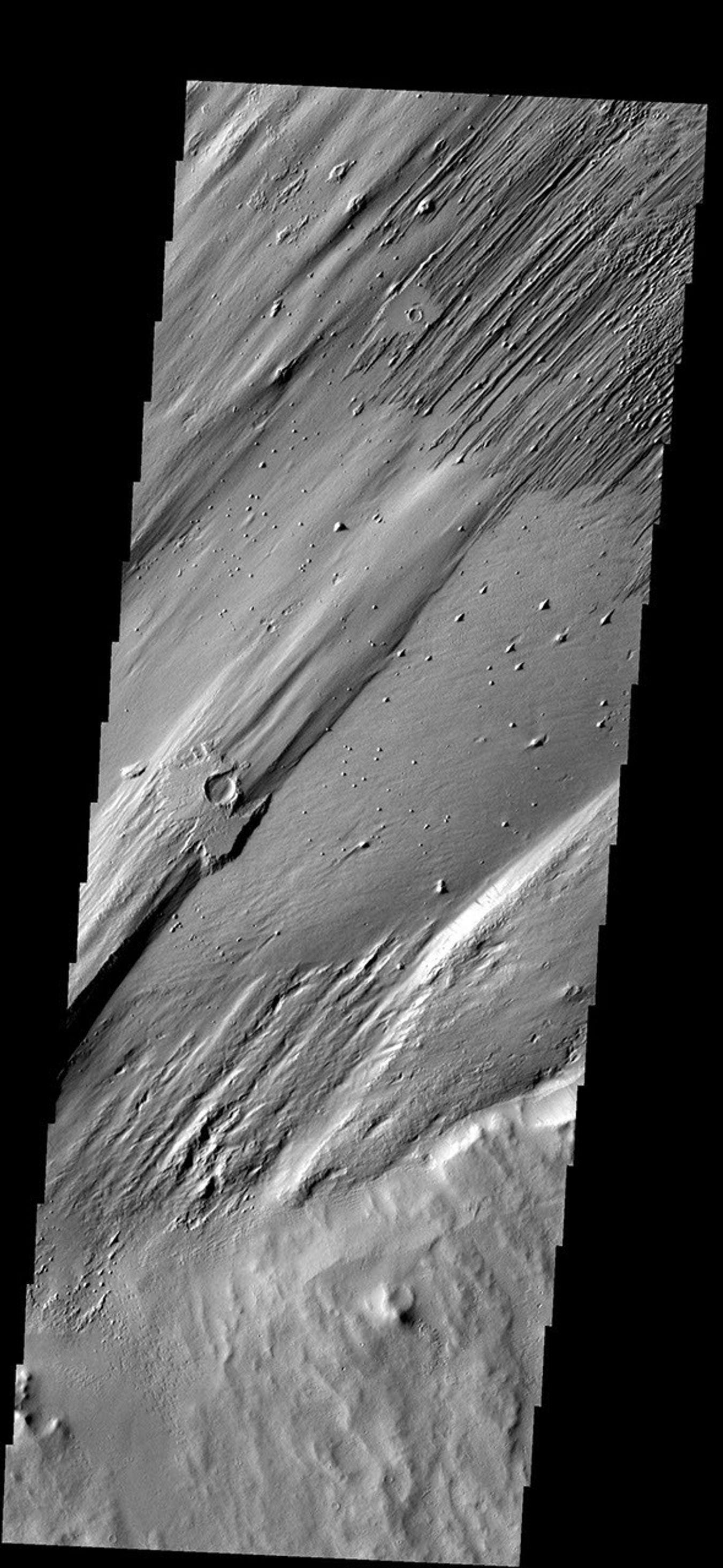 Only a portion of the ejecta remains around this crater. Wind action is creating yardangs and stripping off the surface materials in this region on Mars as seen by NASA's Mars Odyssey spacecraft.