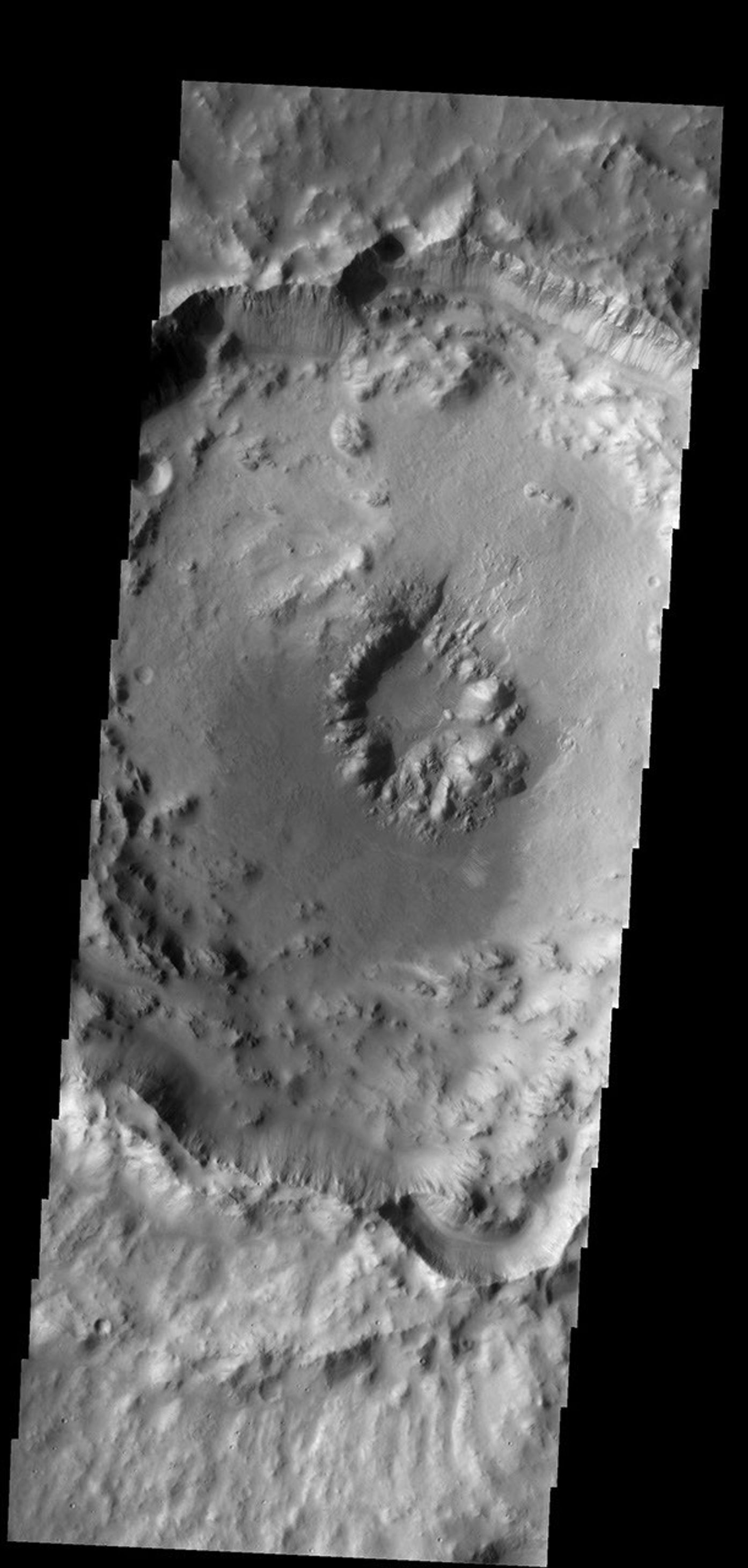 This crater with a central pit is located in Arabia Terra on Mars as seen by NASA's Mars Odyssey spacecraft.
