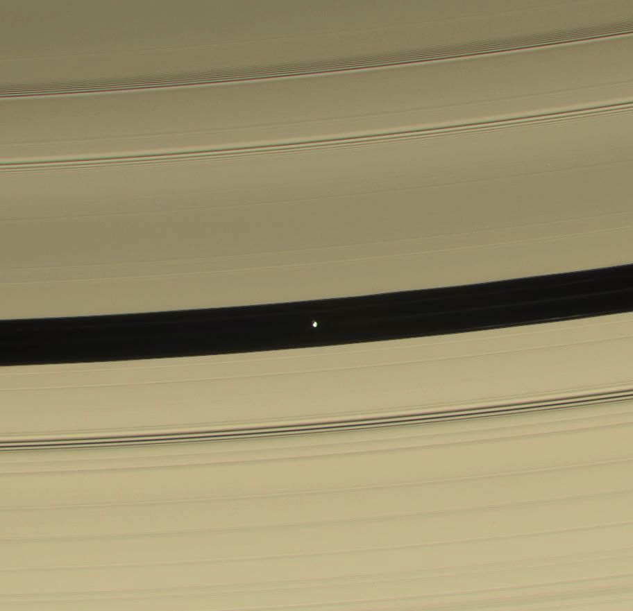 Pan is seen in this color view as it sweeps through the Encke Gap with its attendant ringlets. This image is from NASA's Cassini spacecraft.