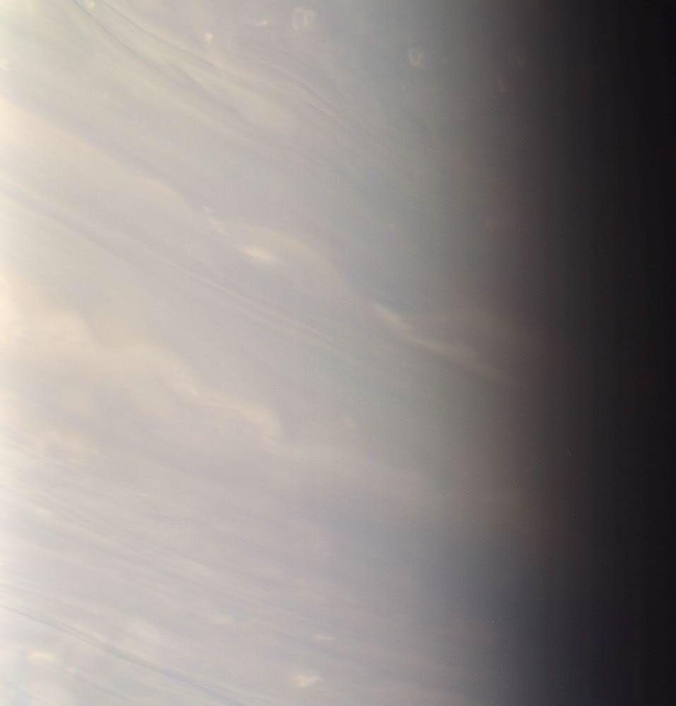 In Saturn's bluish north, day ends for the dreamy white clouds that stretch here into twilight as seen by NASA's Cassini spacecraft.