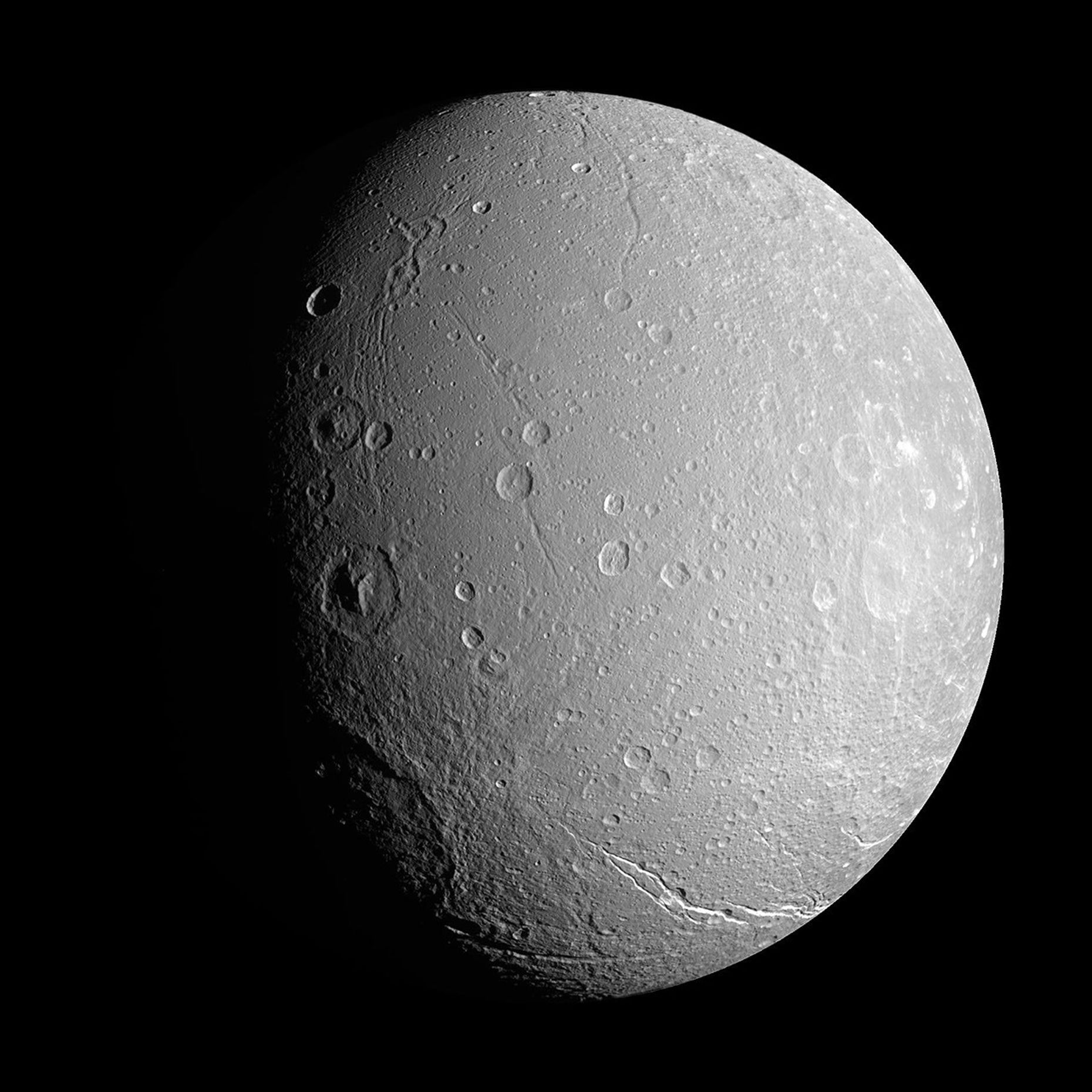 NASA's Cassini spacecraft investigates the craters and deep valleys on Dione during a close approach in April 2007.