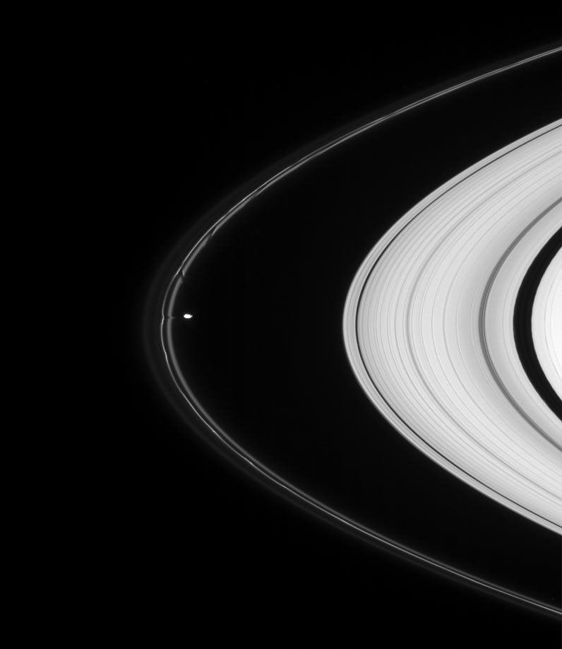 Saturn's moon Prometheus pulls material from the tortured F ring in this detailed view. The aftereffects of the moon's other recent encounters with the ring are visible above as dark channels in the inner ringlet as seen by NASA's Cassini spacecraft.