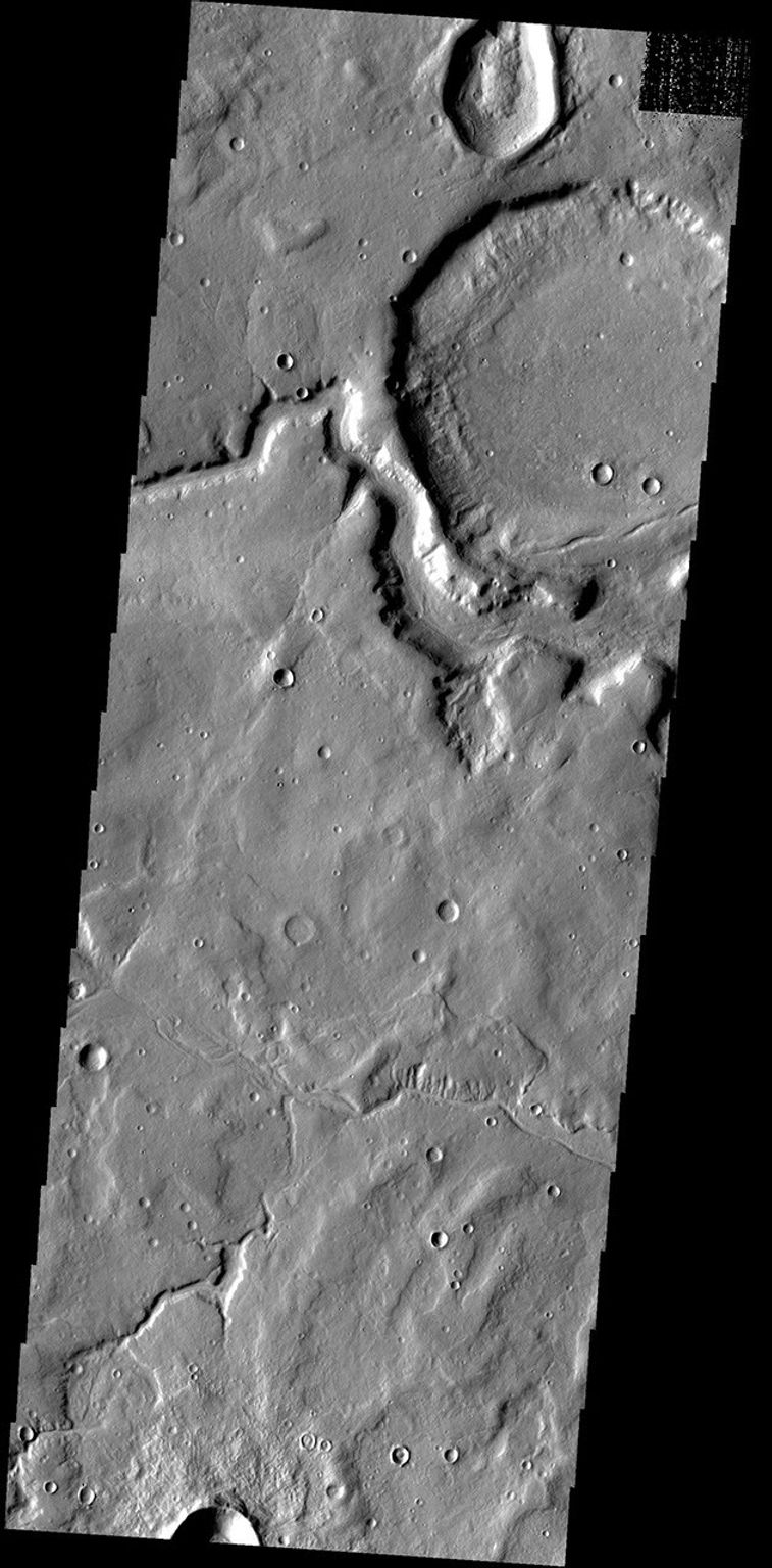 This unnamed crater near Timoshenko Crater has been breached by a channel on Mars as seen by NASA's Mars Odyssey spacecraft.