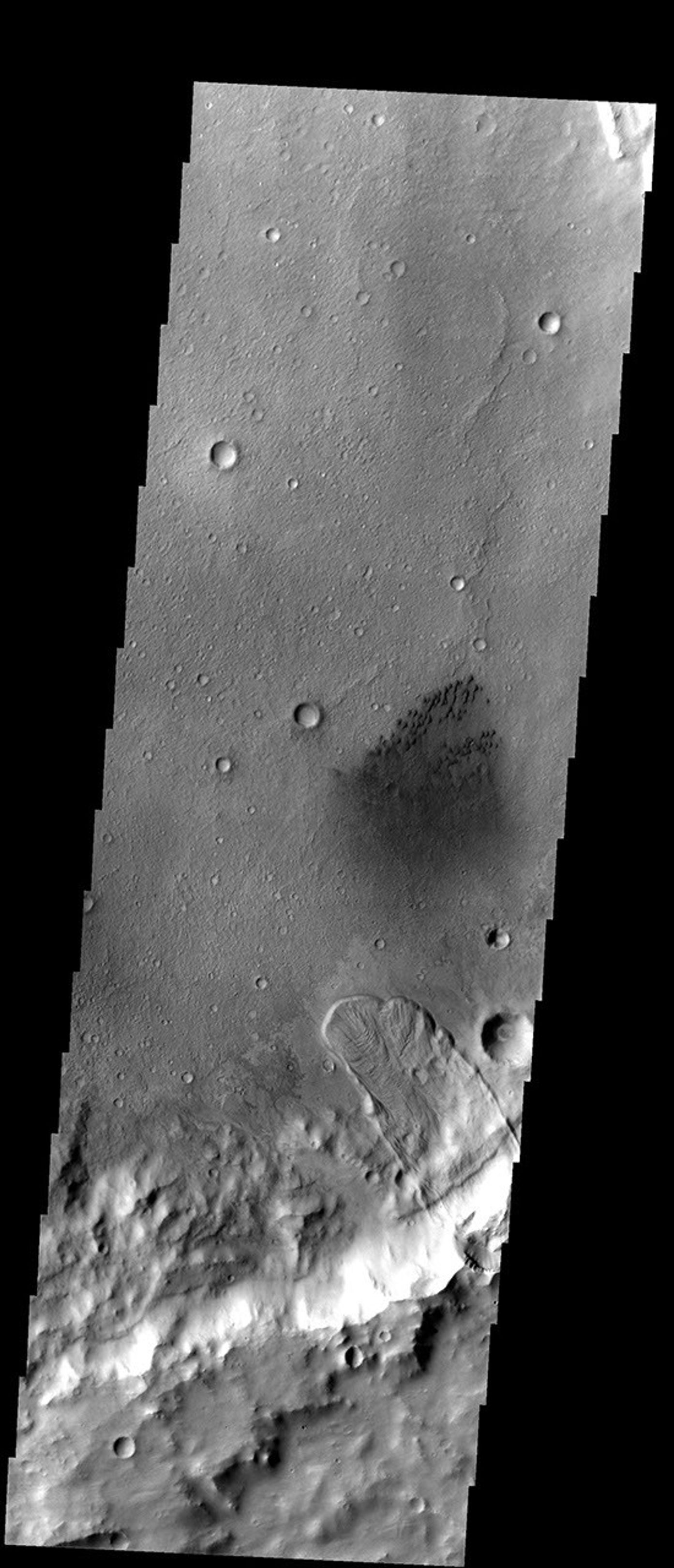 This unnamed crater east of Herschel Crater contains both a large landslide and a field of small dark sand dunes on Mars as seen by NASA's 2001 Mars Odyssey spacecraft.