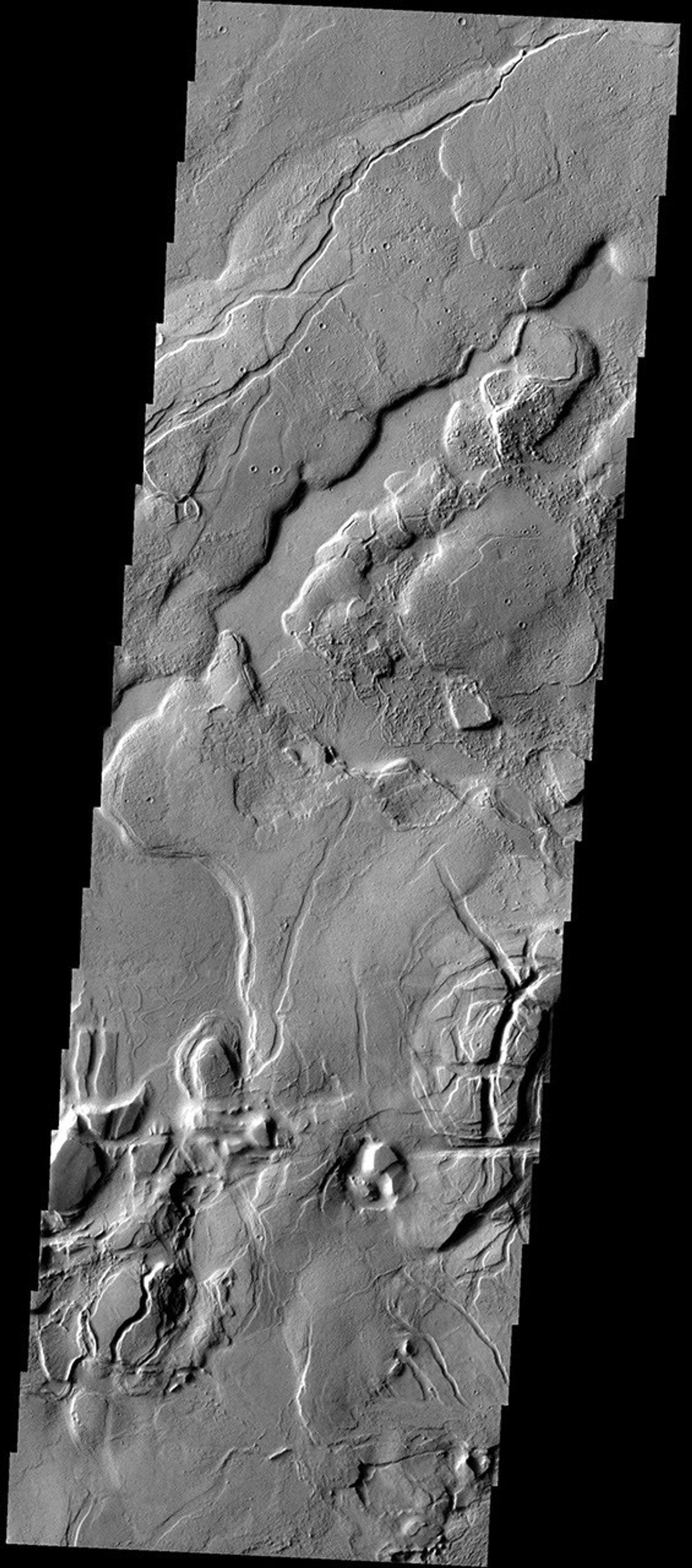 This complex region of lava flows and fracturing is located at the eastern margin of the Tharsis Volcanic Complex on Mars as seen by NASA's 2001 Mars Odyssey spacecraft.