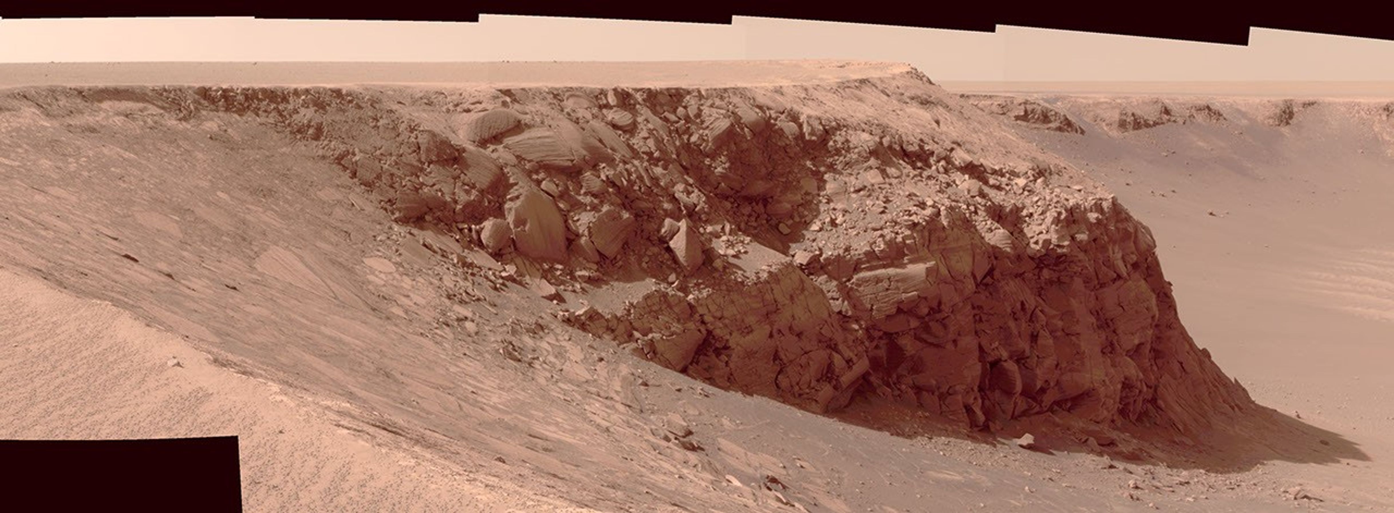 On Dec. 5, 2006, NASA's Mars Exploration Rover Opportunity examined a section of the scalloped rim called Bottomless Bay in Victoria Crater on Mars. The upper portion of the crater wall contains a jumble of material.