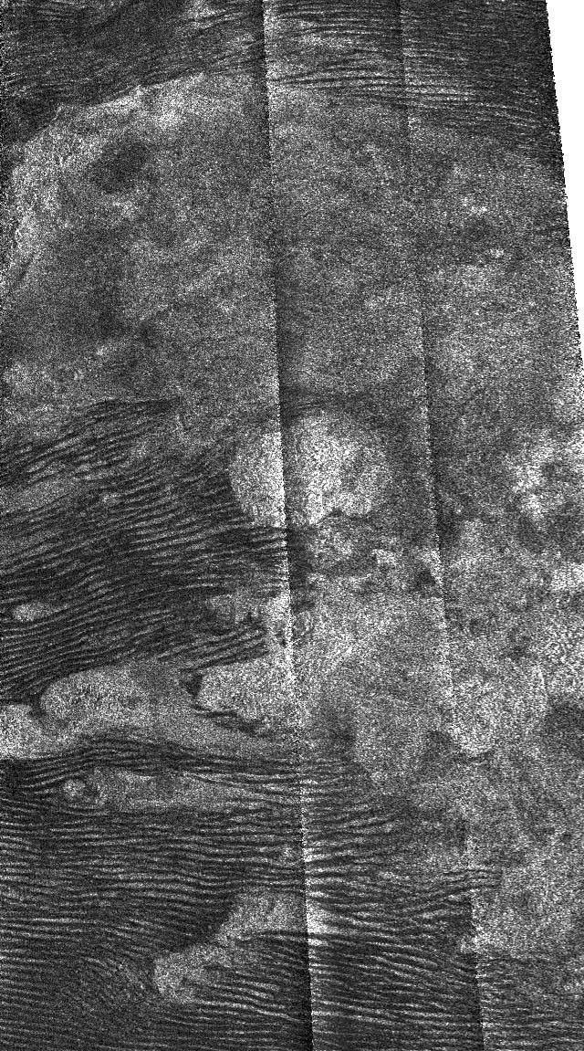 This radar image, obtained by NASA's Cassini's radar instrument during a near-polar flyby on Feb. 22, 2007, shows dunes surrounding a bright feature on Saturn's moon Titan.
