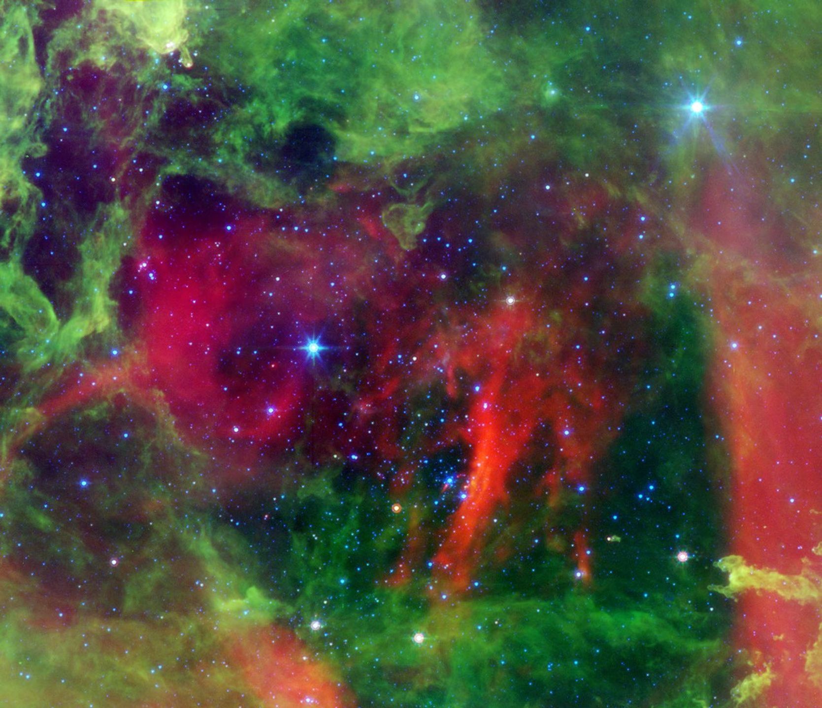 This infrared image from NASA's Spitzer Space Telescope shows the Rosette nebula, a pretty star-forming region more than 5,000 light-years away in the constellation Monoceros.