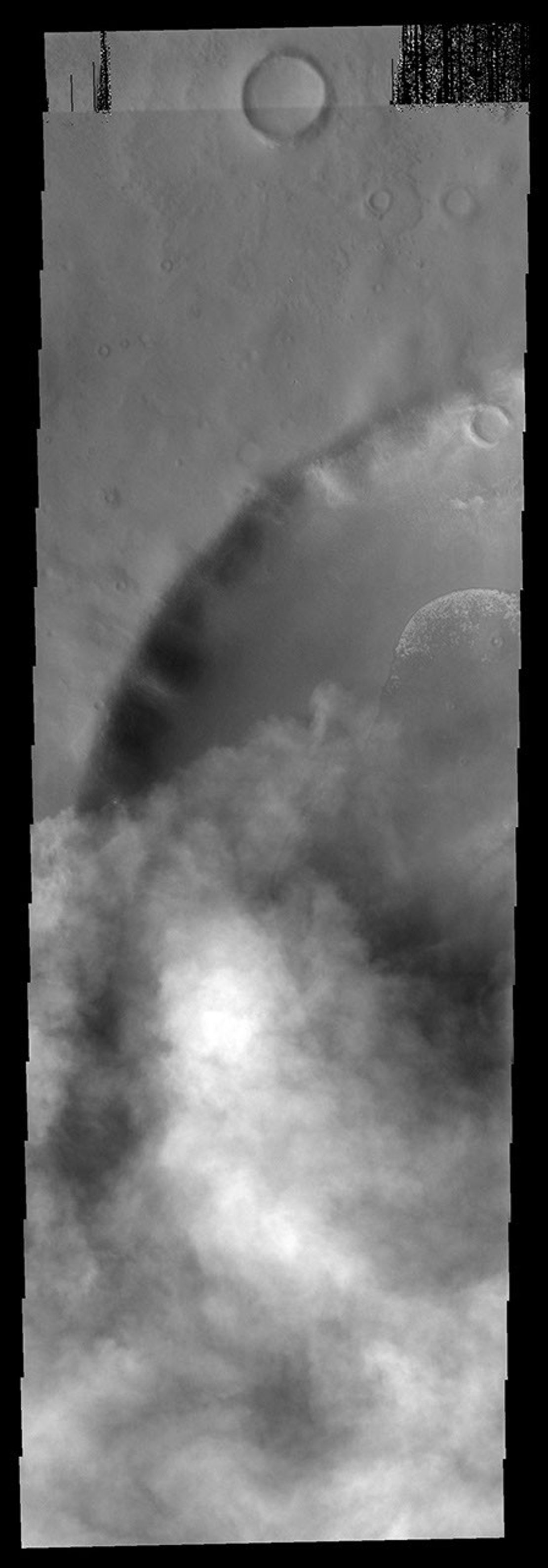 This image from NASA's Mars Odyssey spacecraft shows an unnamed crater southeast of Hellas Basin with an encroaching storm in the region.