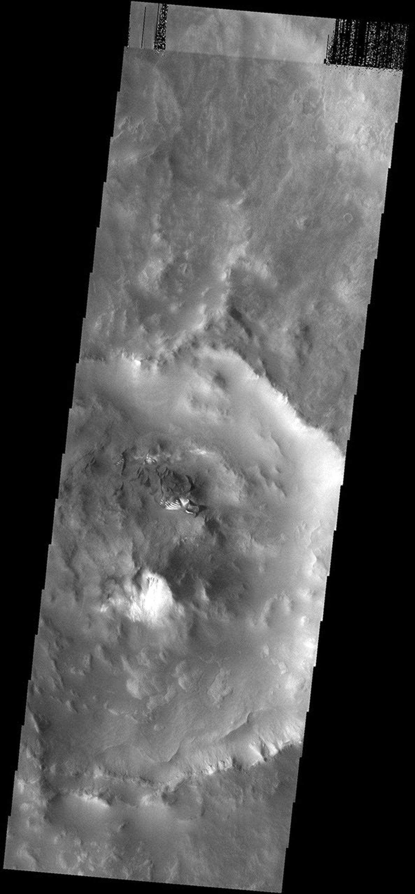 This image from NASA's Mars Odyssey spacecraft shows small dunes located on the rough floor of an unnamed crater next to the much larger Russell Crater. The bright material on the southern faces of the dunes is frost.