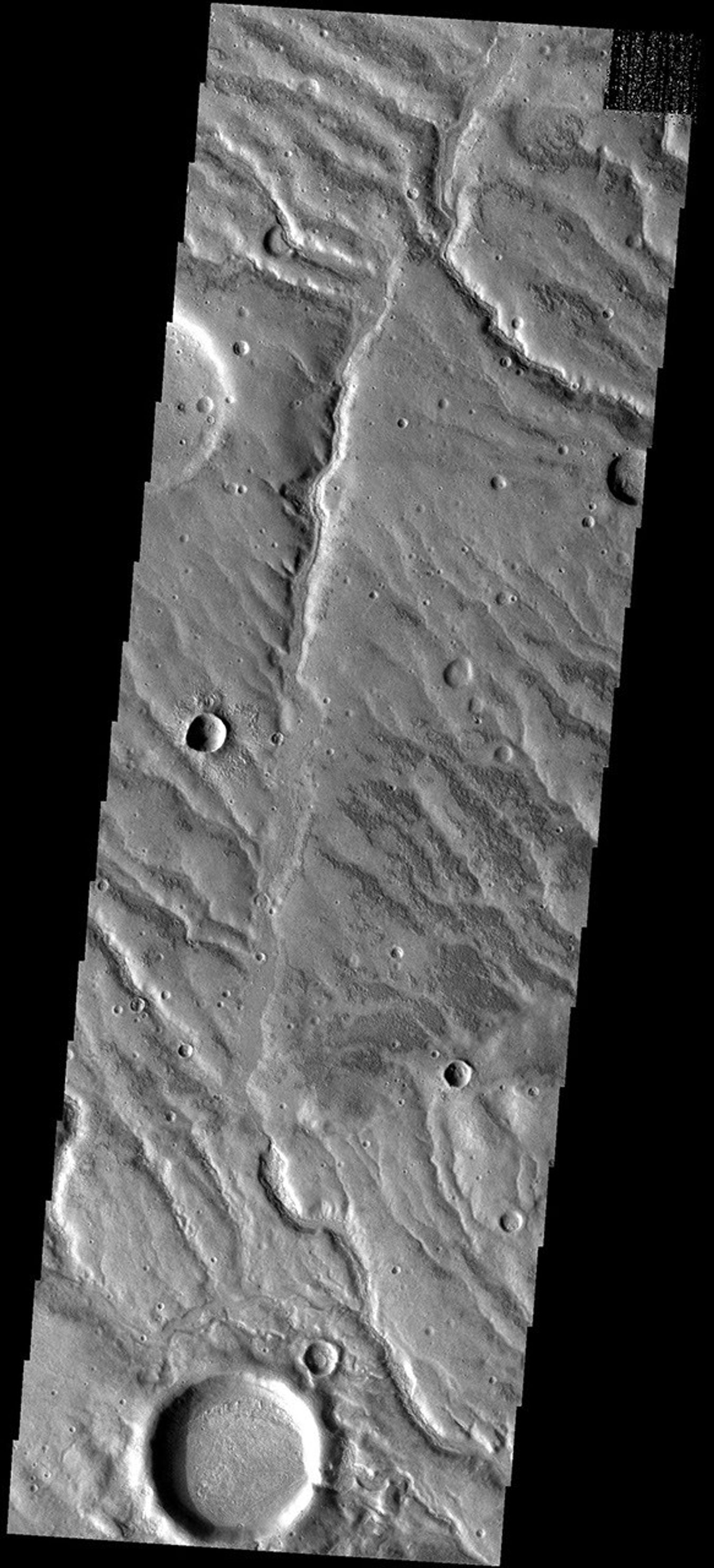 This image from NASA's Mars Odyssey spacecraft shows dissected surface located in highlands between Solis Planum and Aonia Terra. These channels were likely carved by running water.