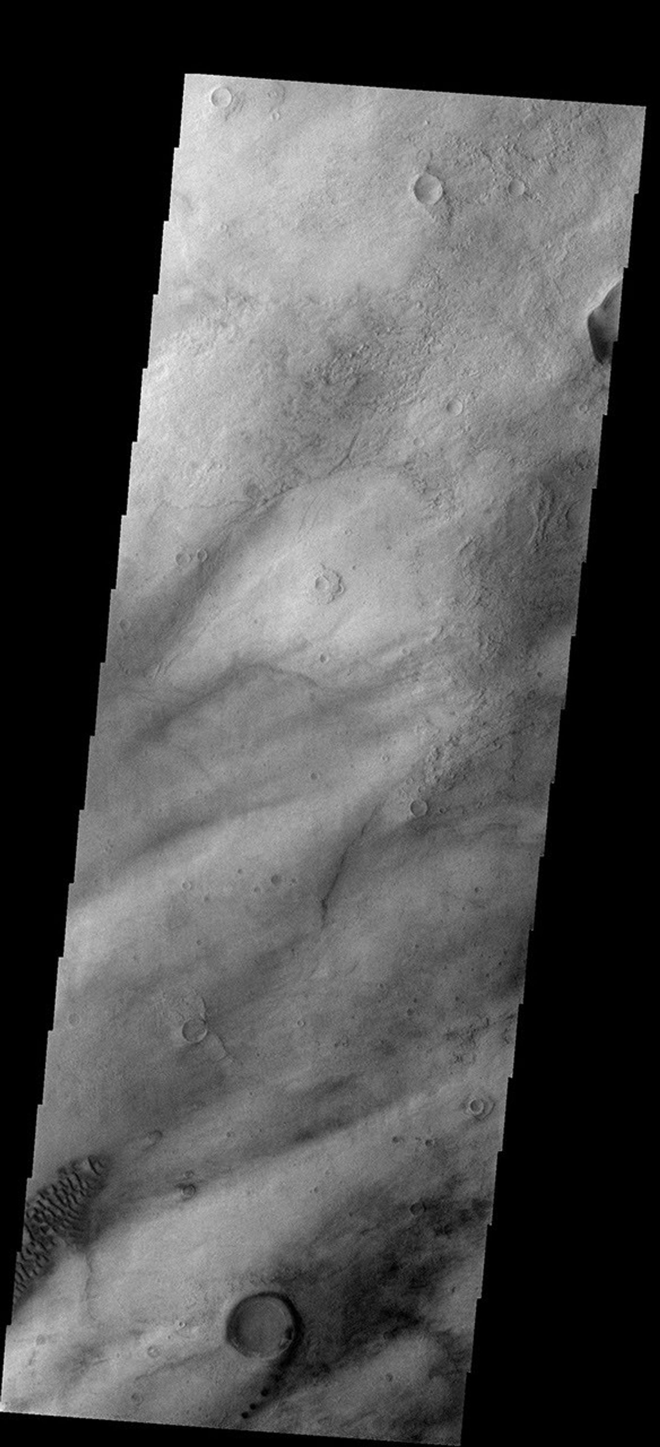 This THEMIS as art image from NASA's Mars Odyssey spacecraft shows small dark dunes in the Hellas Basin trailing the rim and southern margin of this small crater the overall effect is the appearance of the number 9.