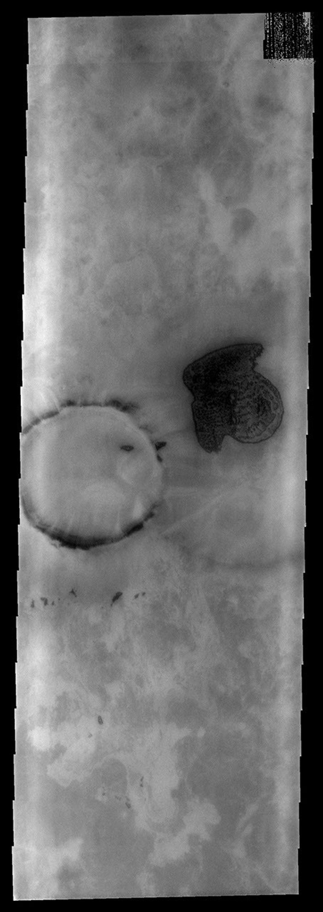 This THEMIS as art image from NASA's Mars Odyssey spacecraft shows a dune field in this polar region crater looking like a stubby arrow pointing the way west. This unnamed crater is located in Planum Chronium.