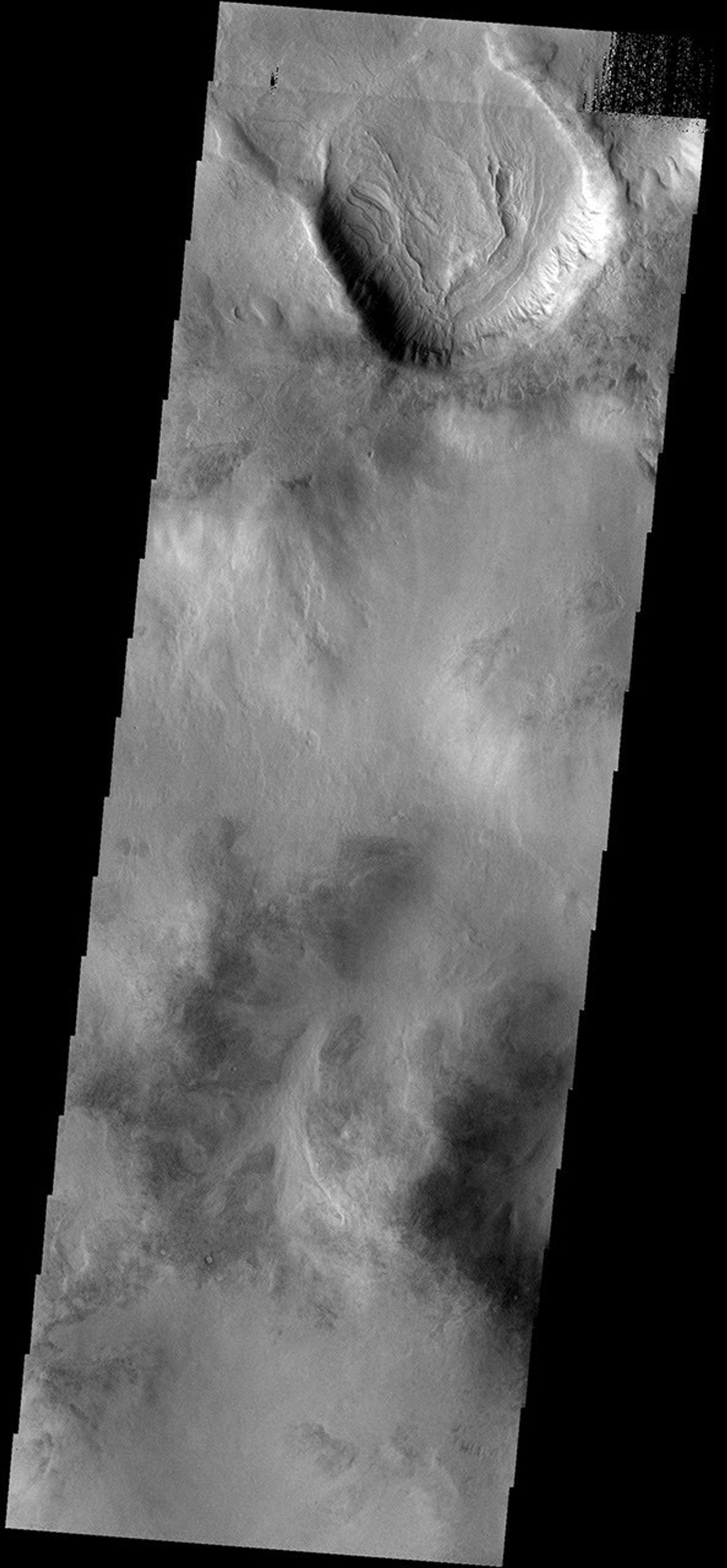 This image from NASA's Mars Odyssey spacecraft shows the floor of an unnamed crater in Aonia Terra has been filled with multiple layers of material.