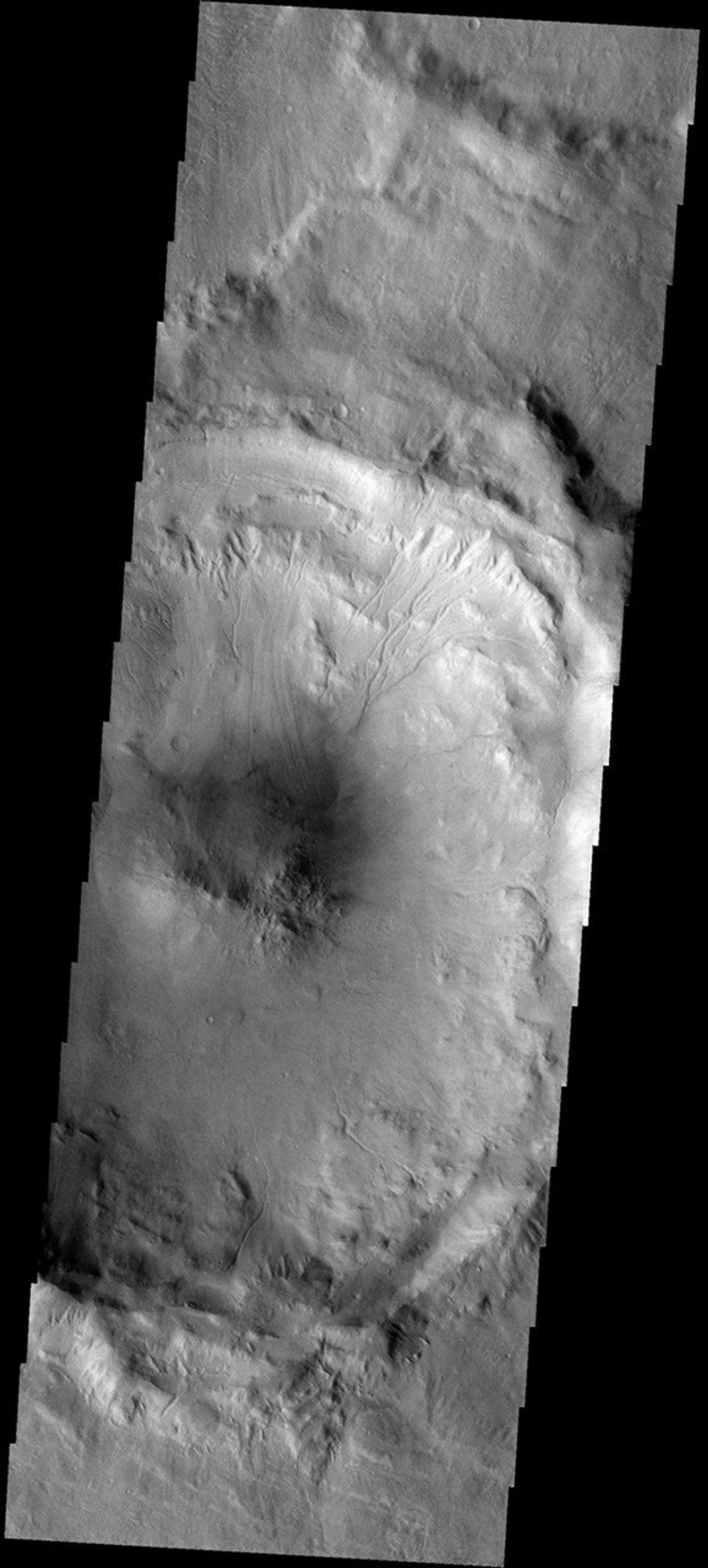 This image from NASA's Mars Odyssey spacecraft shows an unnamed central peak crater east of Hadriaca Patera on Mars. The crater rim is cut by multiple channels and part of the rim has failed.