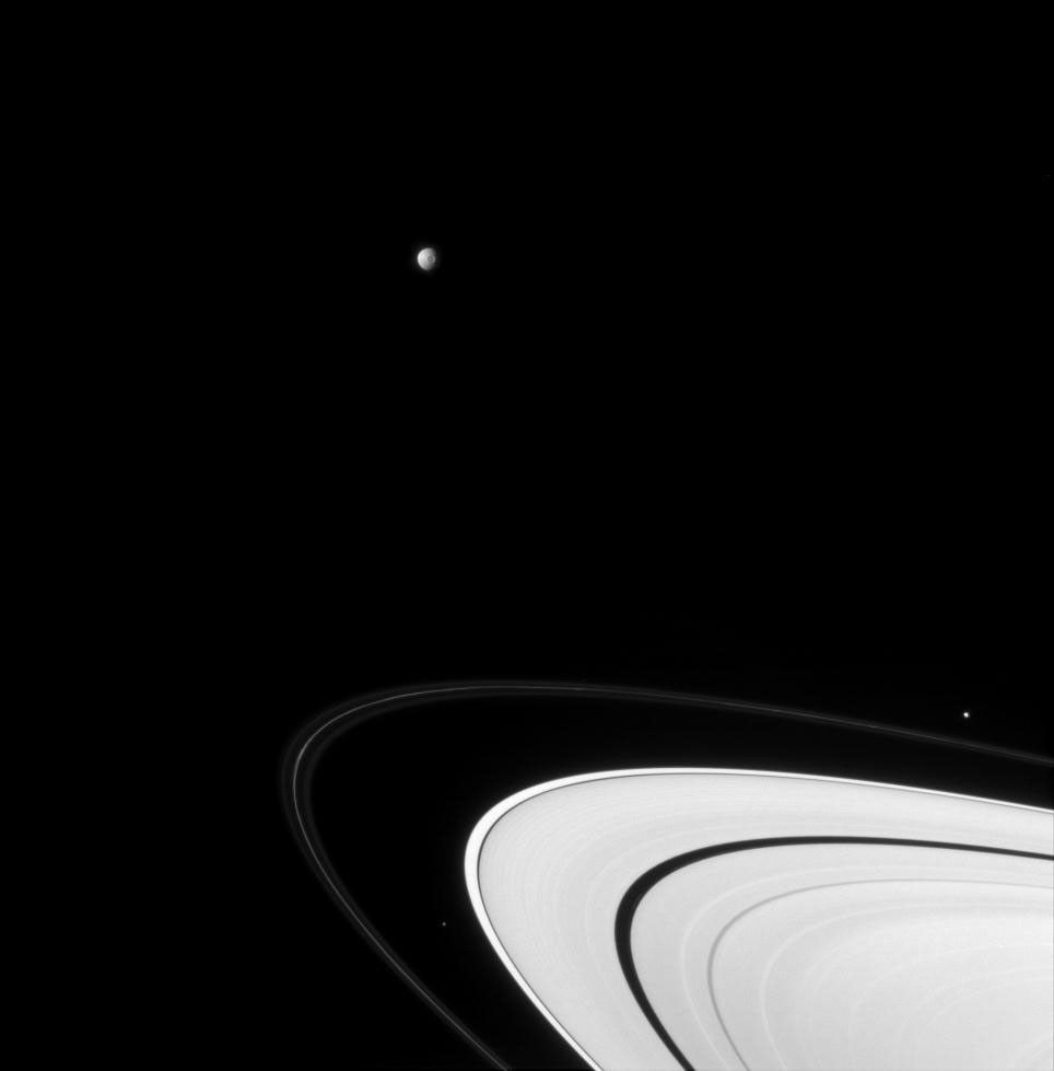 NASA's Cassini spacecraft captured Mimas and Pandora, as well as Herschel crater, as they hurtle around the vast icy disk of Saturn's rings, in this view taken on Sept. 19, 2007.
