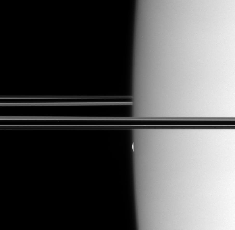 NASA's Cassini spacecraft watches a thin, bright sliver emerge from the hazy limb of Saturn. In one minute, the sliver ballooned into the full disk of Mimas in this image taken on Oct. 26, 2007.
