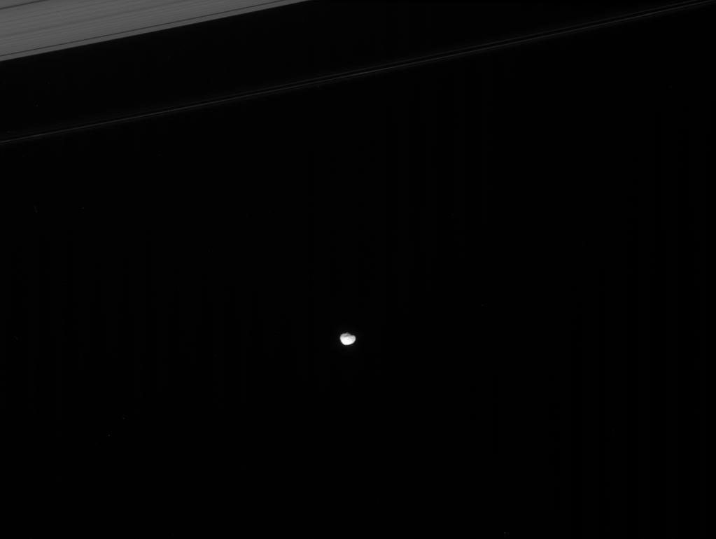 Janus skirts the edges of Saturn's main rings. NASA's Cassini spacecraft has shown that this small moon and its co-orbital companion, Epimetheus, also share their orbit with a diffuse ring of fine particles.