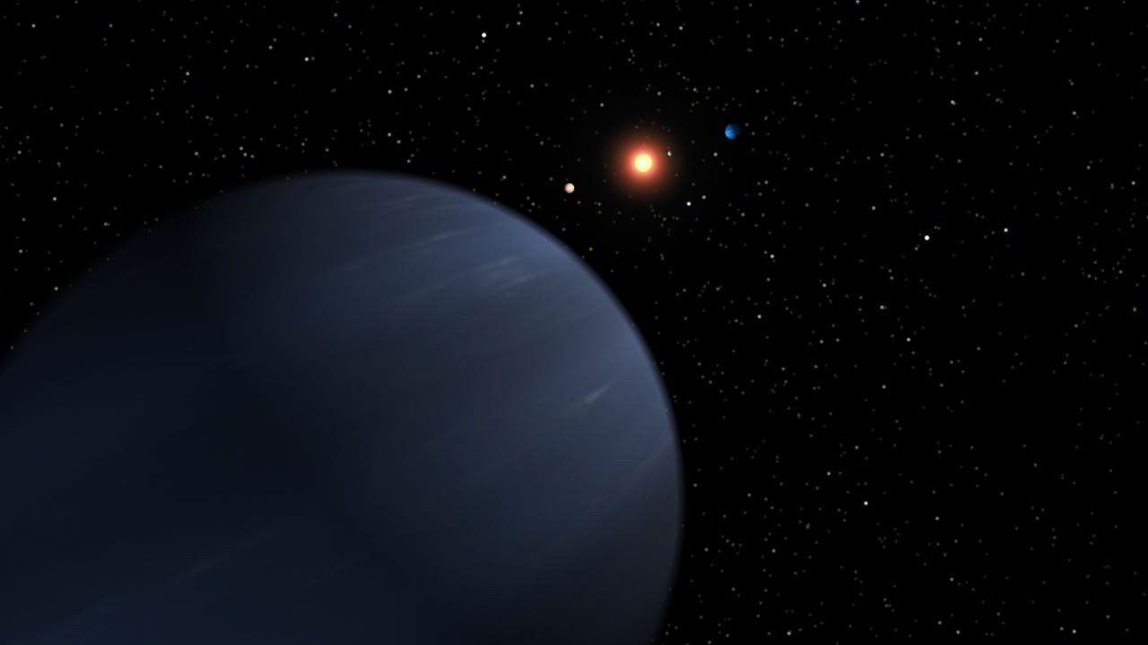 This artist's concept shows four of the five planets that orbit 55 Cancri, a star much like our own. The most recently discovered planet, and the fourth out from the star, looms large in the foreground.