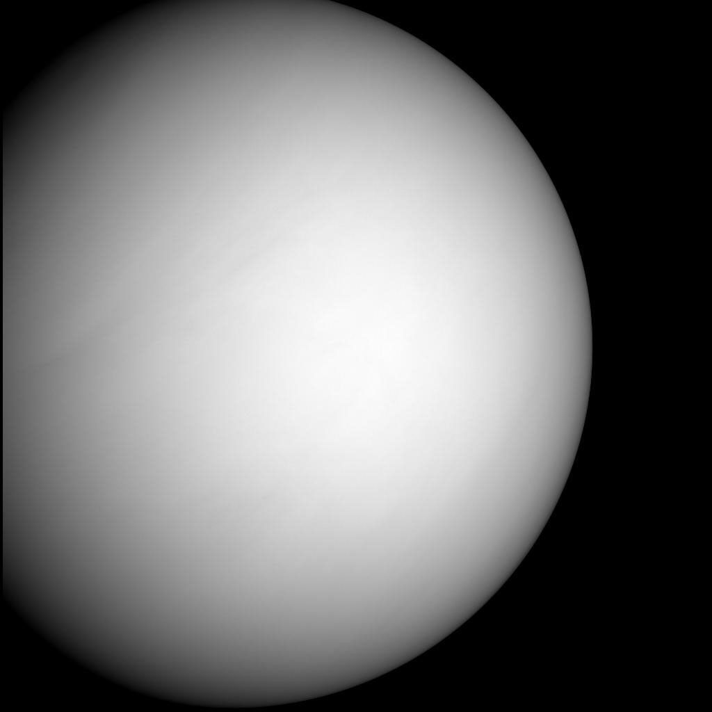 Venus appears like a gray orb against the darkness of space.