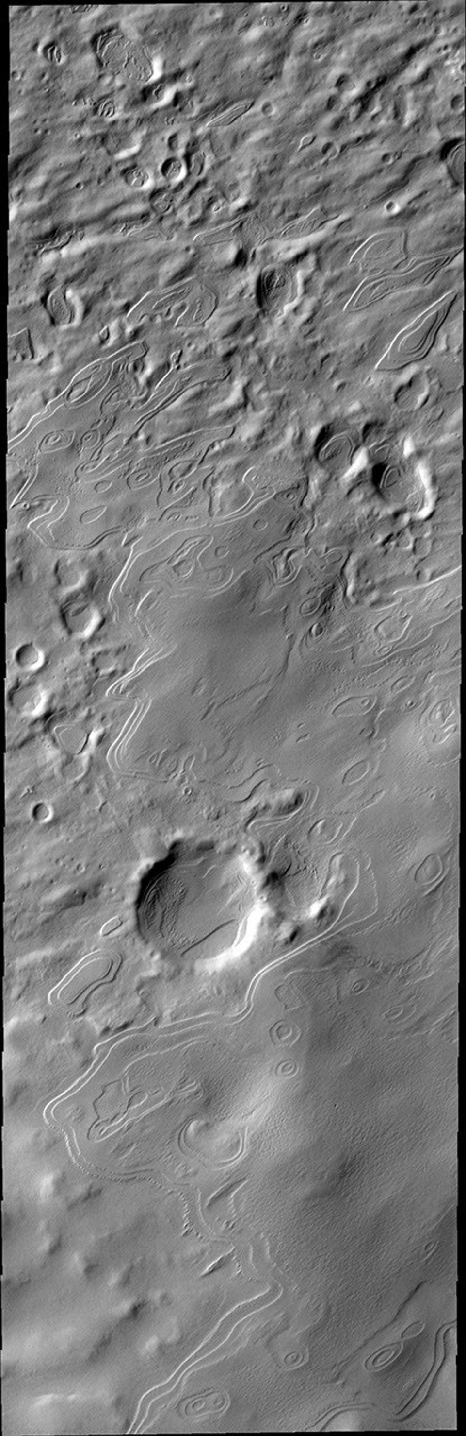 This image from NASA's Mars Odyssey spacecraft shows layered mounds are south polar layered deposits that are no longer part of Mars' south polar cap. Their location marks a time when the permanent polar cap was more extensive.