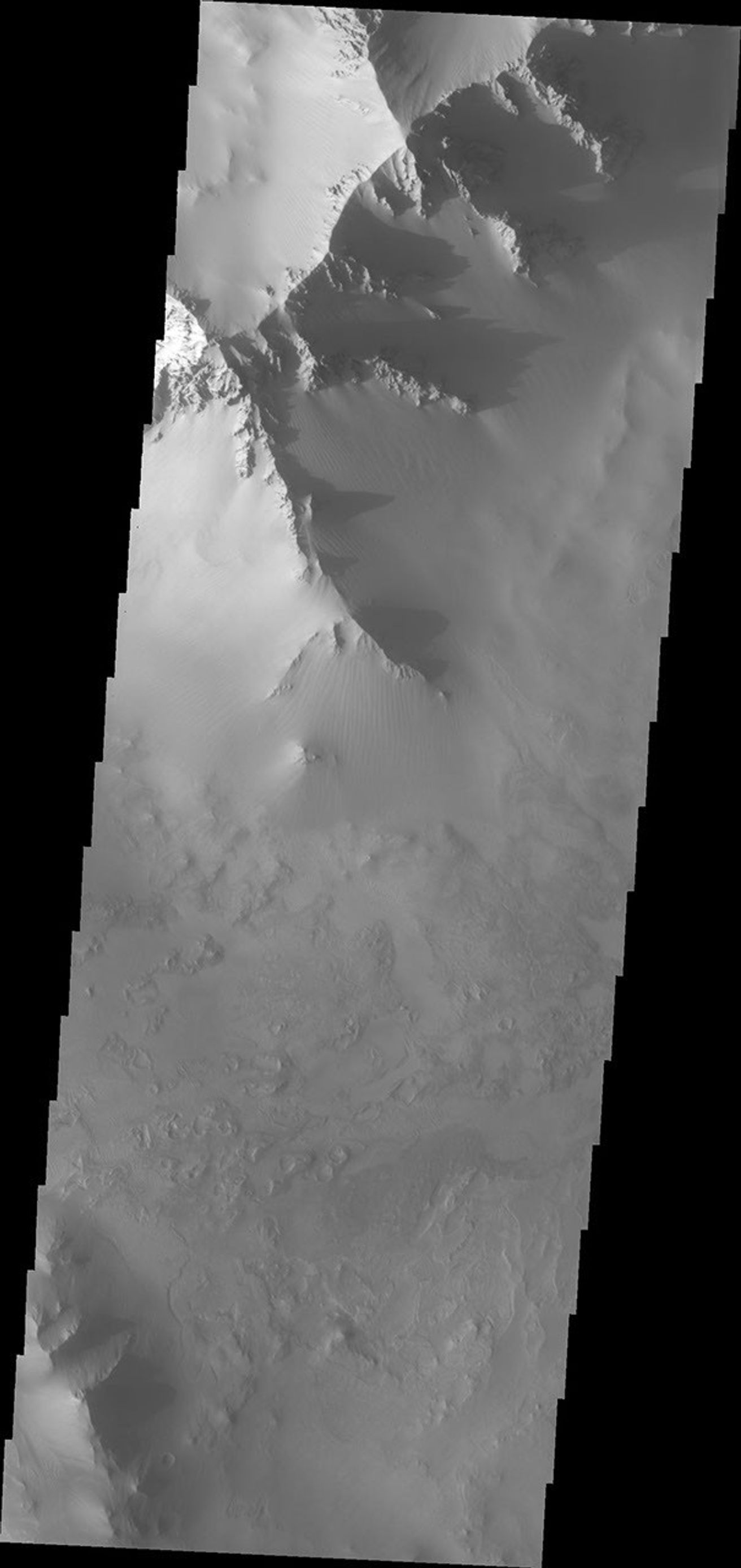 This image from NASA's Mars Odyssey spacecraft shows majestic ridges and their shadows marking the boundary between the Valles Marineris canyon system and Noctis Labyrinthus.