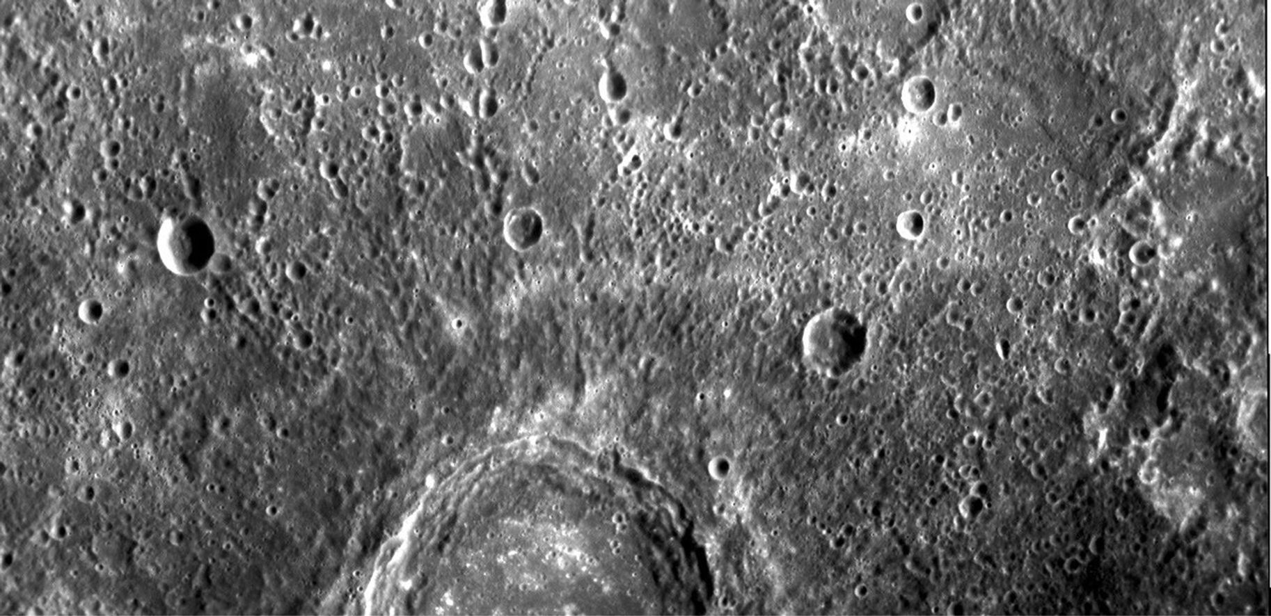 The image shows part of a large, fresh crater with secondary crater chains located near Mercury's equator on the side of the planet newly imaged on January 14, 2008 by NASA's MESSENGER spacecraft.