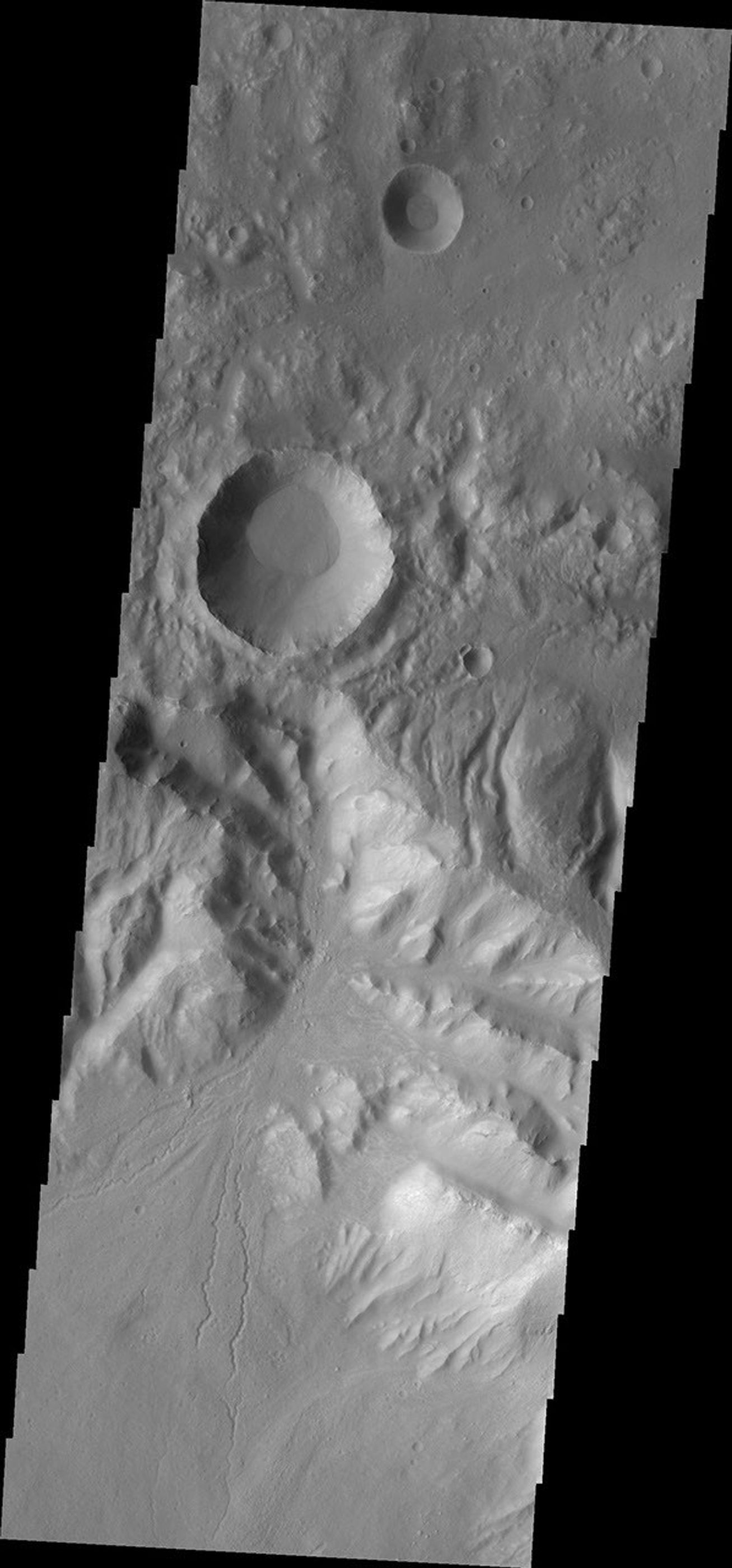 This image from NASA's Mars Odyssey shows a crater located near Hellas Basin containing fine scale channels that originate on the rim and appear to have created an alluvial fan.