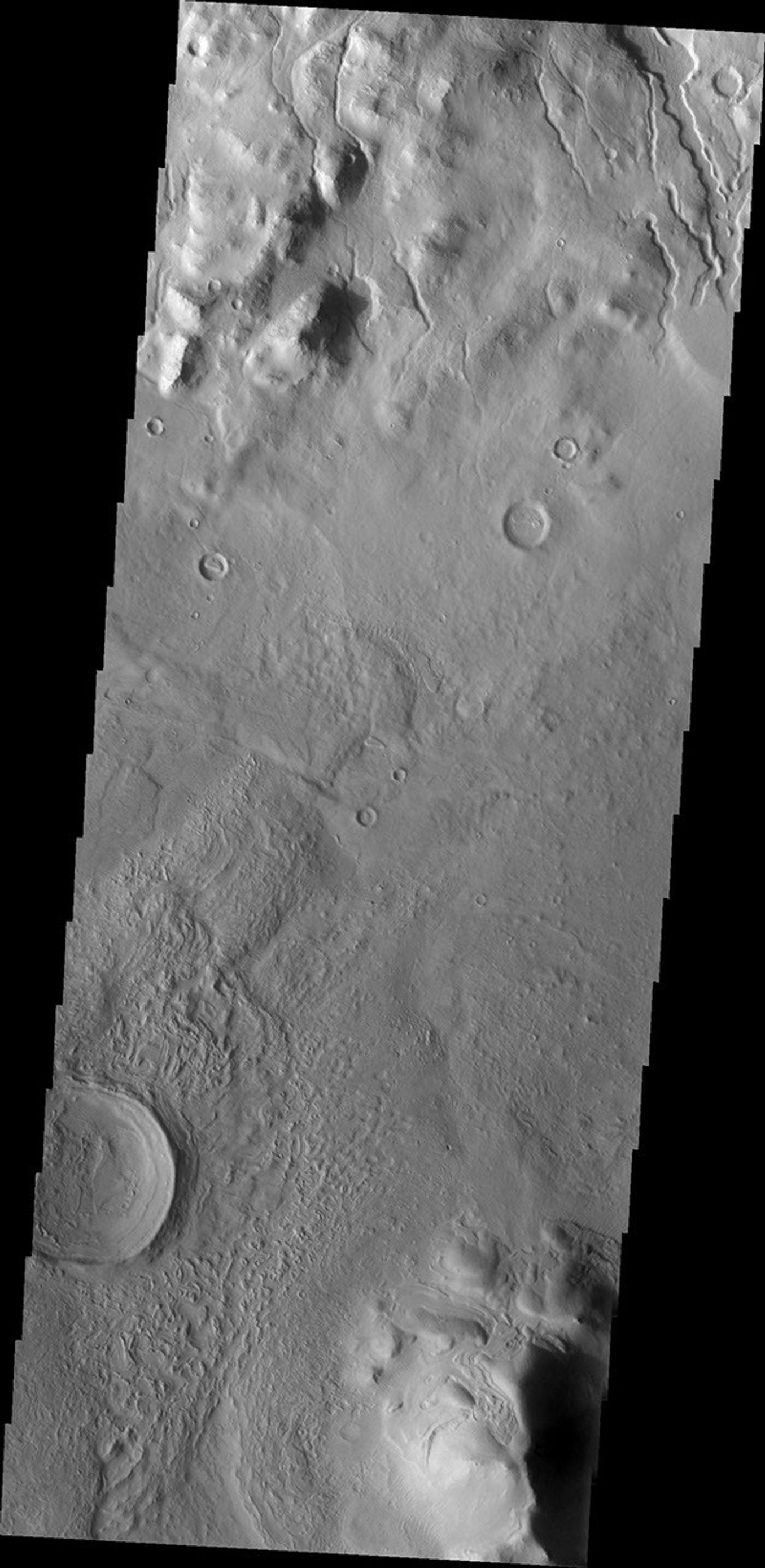 This image from NASA's Mars Odyssey shows channels at the top of this image dissecting the northern rim of Cerulli Crater on Mars.