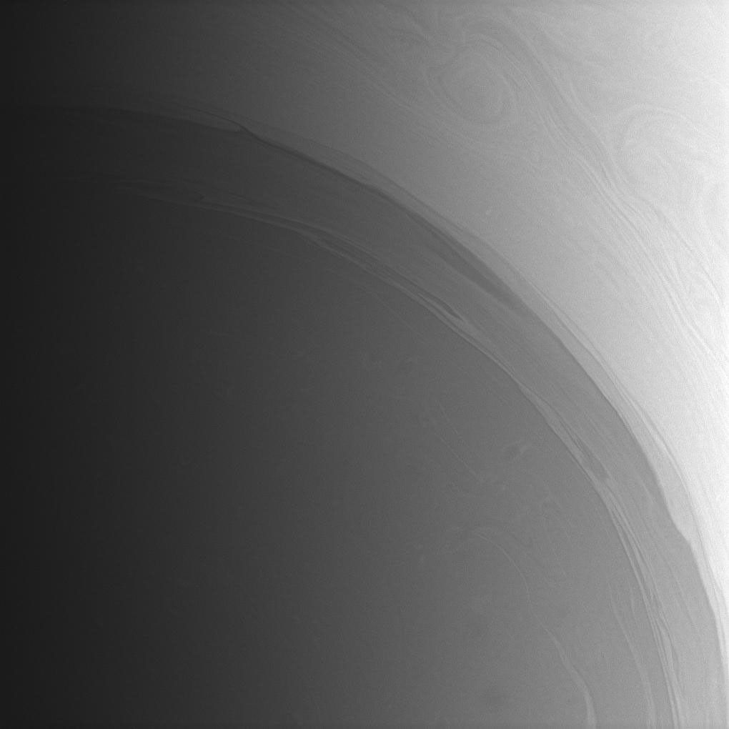 Long streamers of cloud encircle the south polar region of Saturn. Farther poleward, or toward lower left, faint, deeper atmospheric structures lurk beneath the haze. This view was taken with NASA's Cassini spacecraft's wide-angle camera on Oct. 2, 2008.