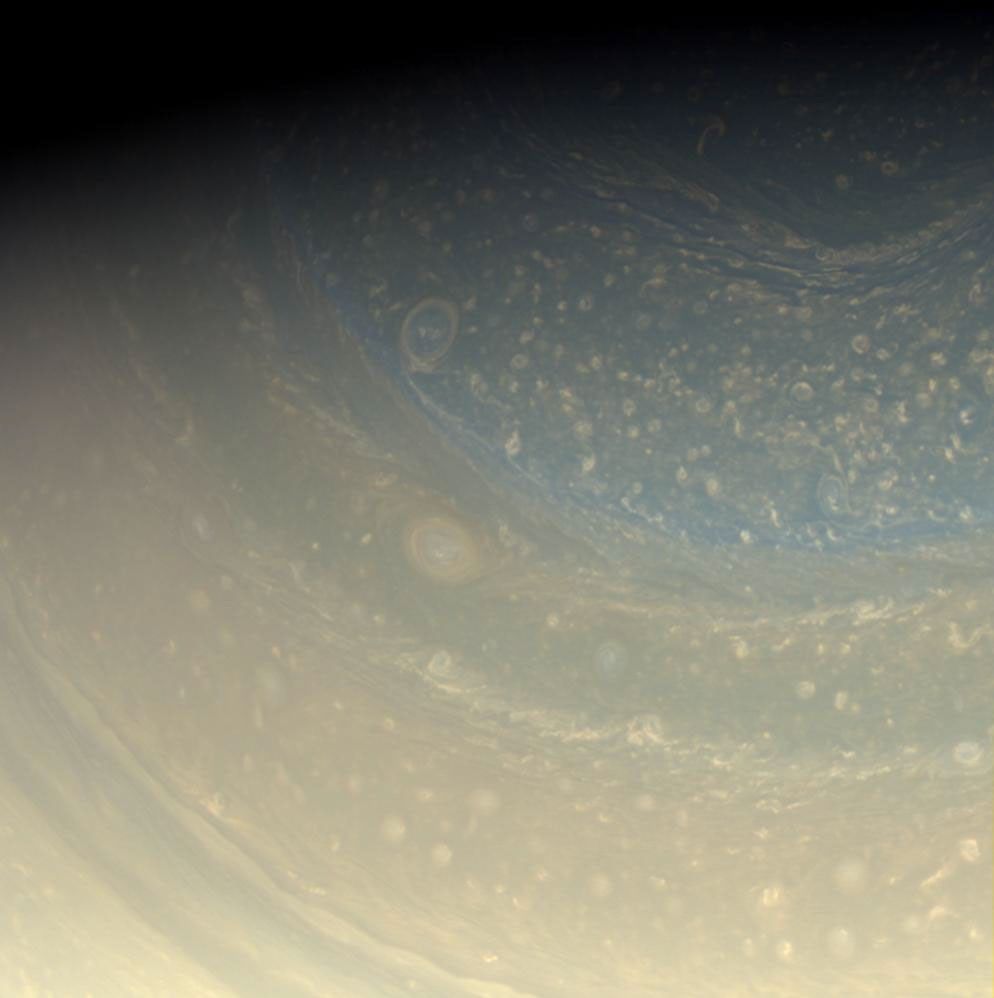 Saturn's north pole is littered with storms, as seen in this color view in hues of pastel yellow of the pole captured by NASA's Cassini spacecraft. A bit of the north polar hexagon is also visible at the upper-right.