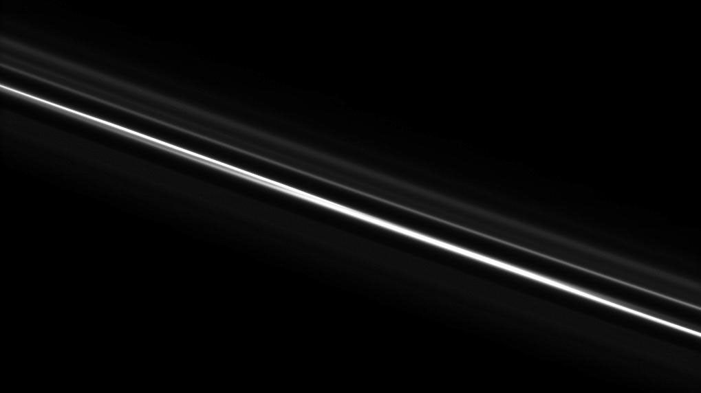 Saturn's F ring, which often appears kinked and gored, looks straight here. Above the brighter core, the ghostly strands of the F ring's outer envelope, with a spiral arm structure, appear in this image taken by NASA's Cassini spacecraft on Nov. 8, 2008.
