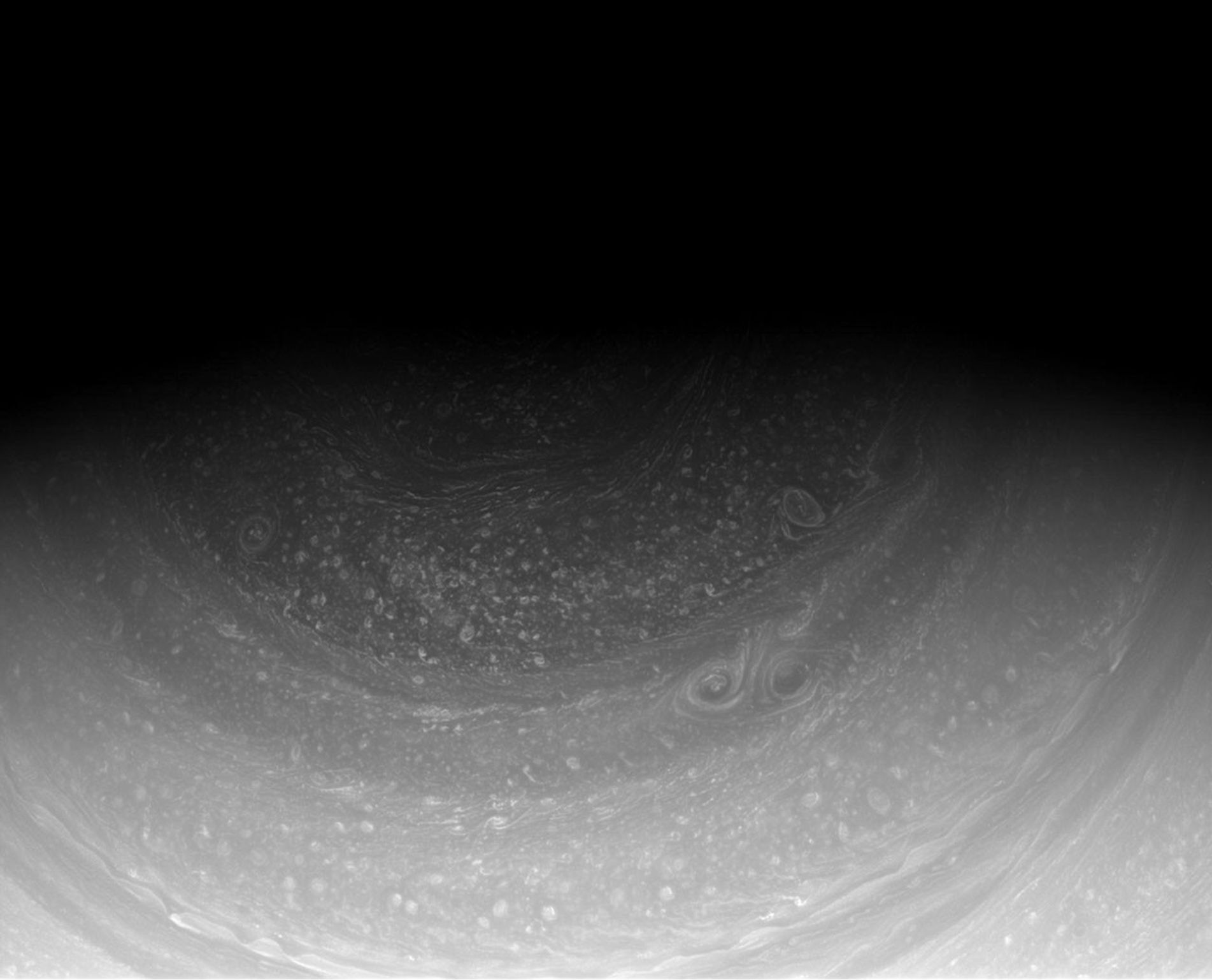Cassini imaging scientists have waited years for the sun to reveal the hexagonal wave pattern in the clouds of Saturn's north pole, part of which can be seen at the top of this image from NASA's Cassini spacecraft.