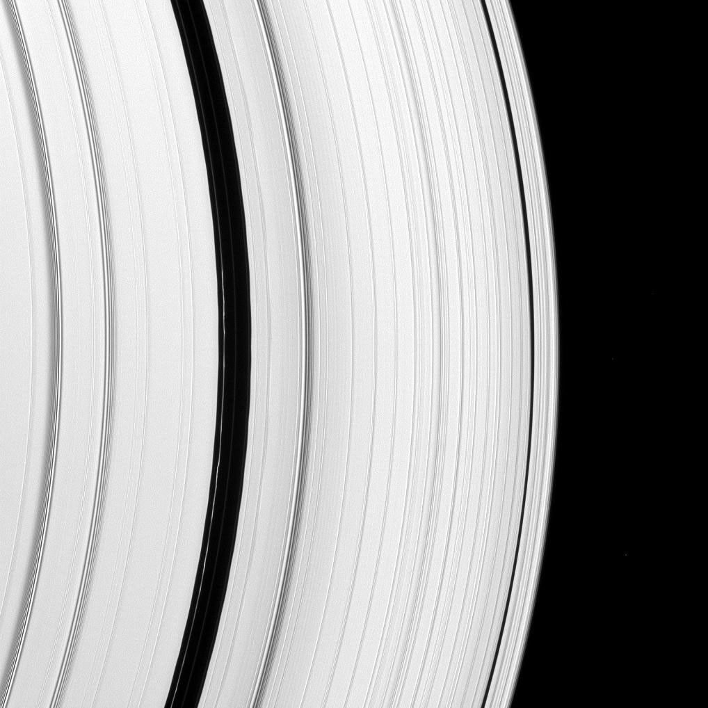 The Encke Gap moon, Pan, has left its mark on a scalloped ringlet of the Encke Gap. The moon creates these perturbations as it sweeps through the gap in the A ring as seen by NASA's Cassini spacecraft.