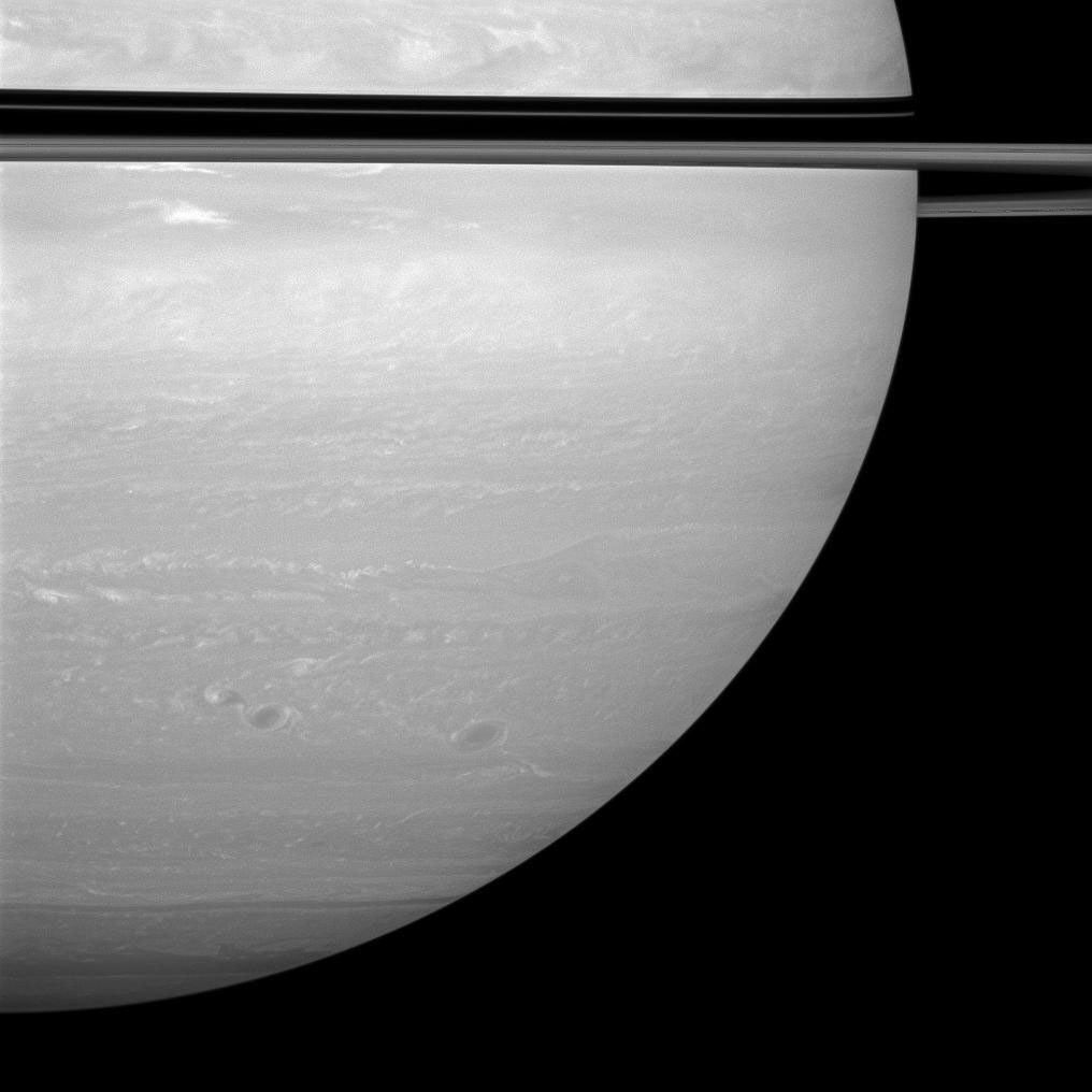 The rings cast a dramatic but narrow shadow on the planet in this view from NASA's Cassini spacecraft on the sunlit side of the rings from just one degree below the ringplane.