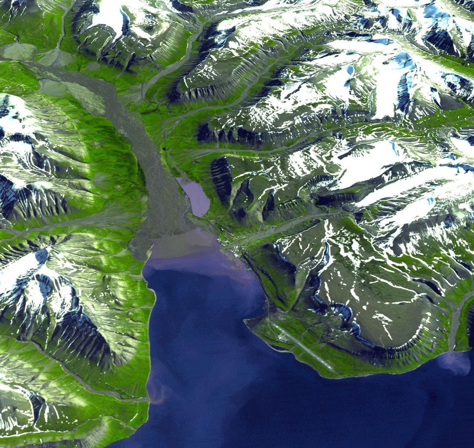 Longyearbyen is the administrative center of Svalbard and is located on Spitsbergen, the largest island of the Svalbard archipelago, part of the Kingdom of Norway. NASA's Terra satellite captured this image on July 12, 2003.