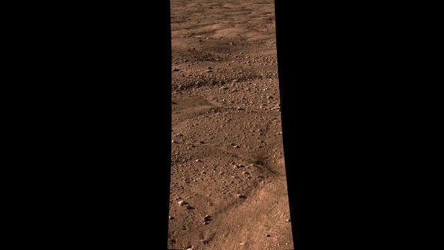This image shows the vast plains of the northern polar region of Mars, as seen by NASA's Phoenix Mars Lander shortly after touching down on the Red Planet. The flat landscape is strewn with tiny pebbles and shows polygonal cracking.
