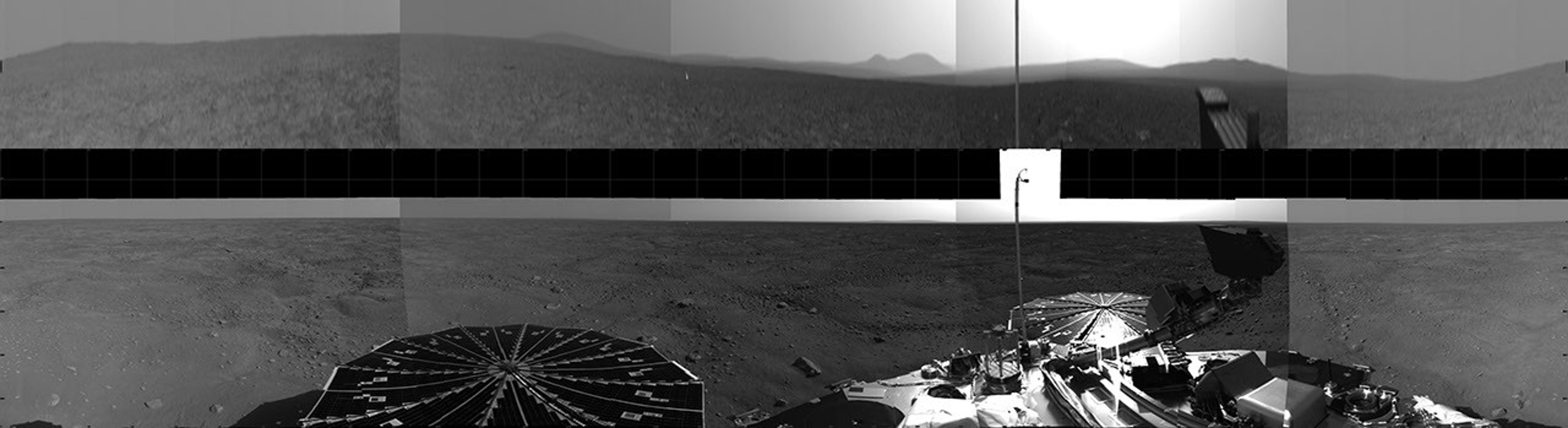 NASA's Phoenix Mars Lander shows details of features on Mars in the background. Phoenix's parachute, backshell, heatshield, and impact site can also be seen.