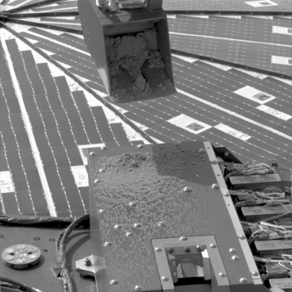 NASA's Phoenix Mars Lander used its Robotic Arm during the mission's 15th Martian day since landing (June 9, 2008) to test a 'sprinkle' method for delivering small samples of soil to instruments on the lander deck.