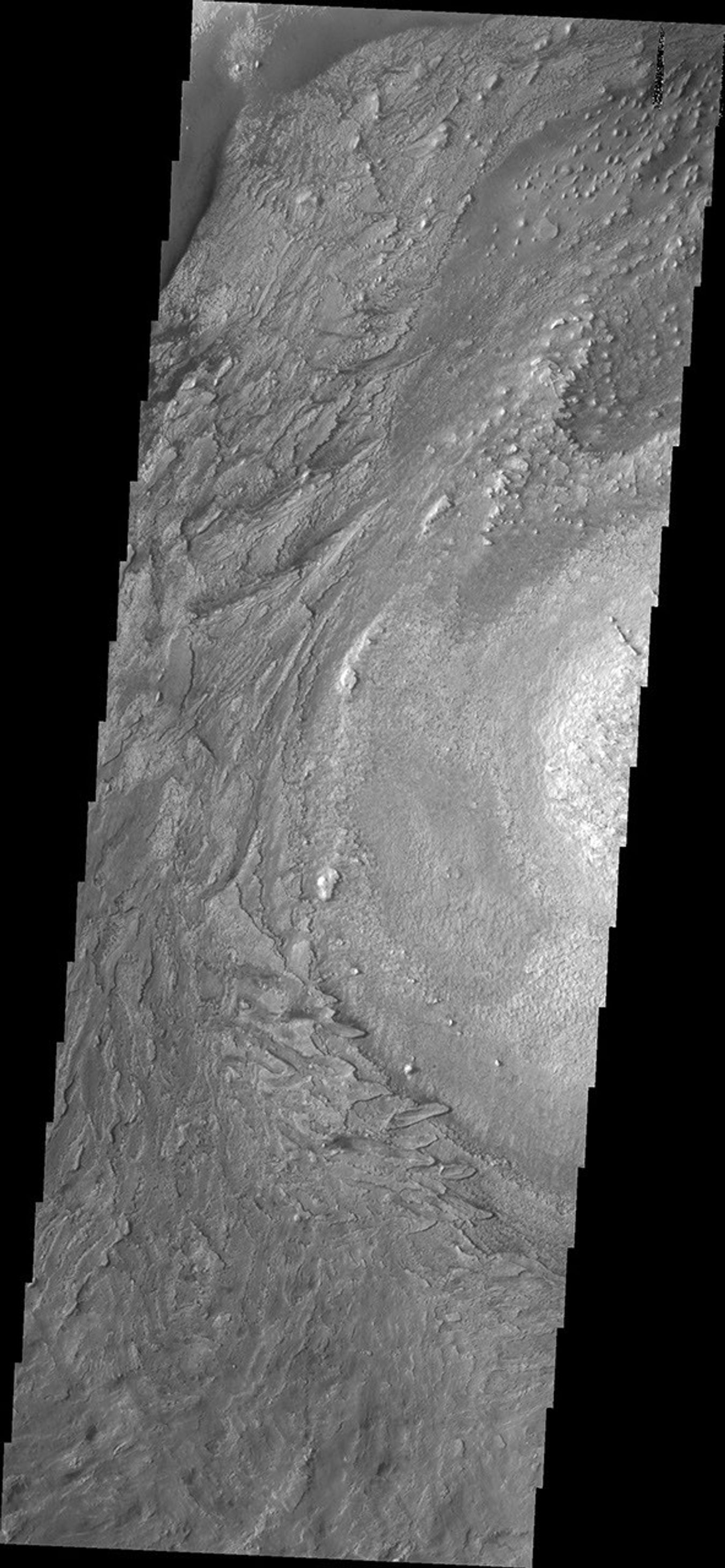 This image from NASA's Mars Odyssey shows textures of the floor material in Crommelin Crater caused by the erosion of a layered deposit within the crater.